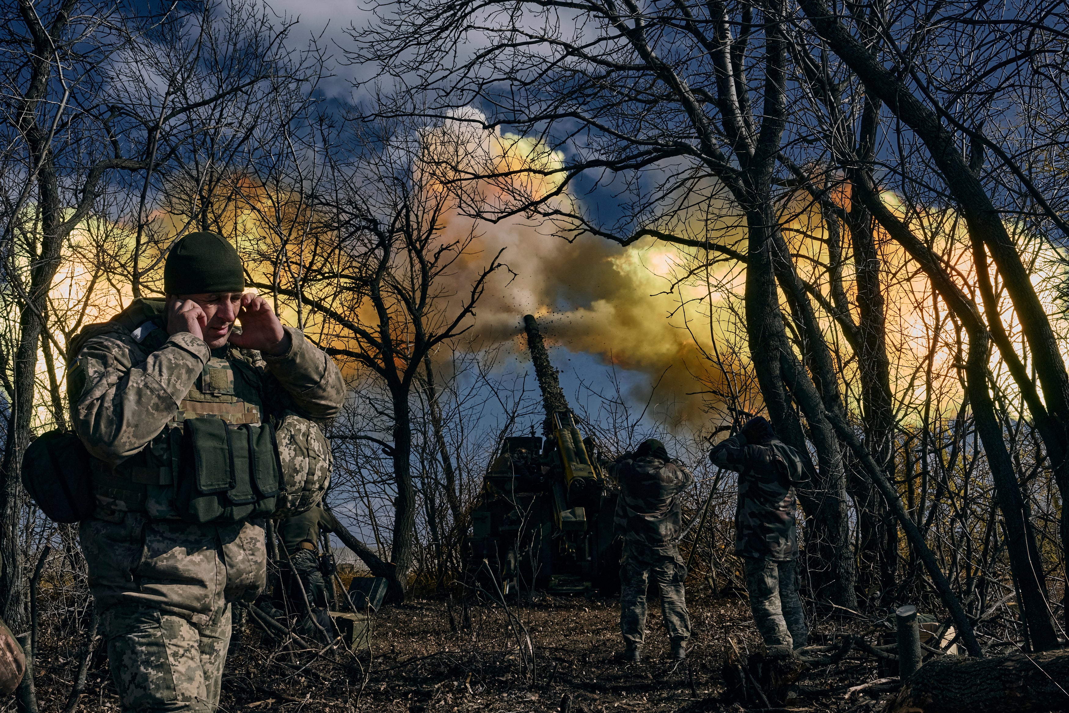 Ukrainian soldiers fire a self-propelled howitzer towards Russian positions near Bakhmut, Donetsk