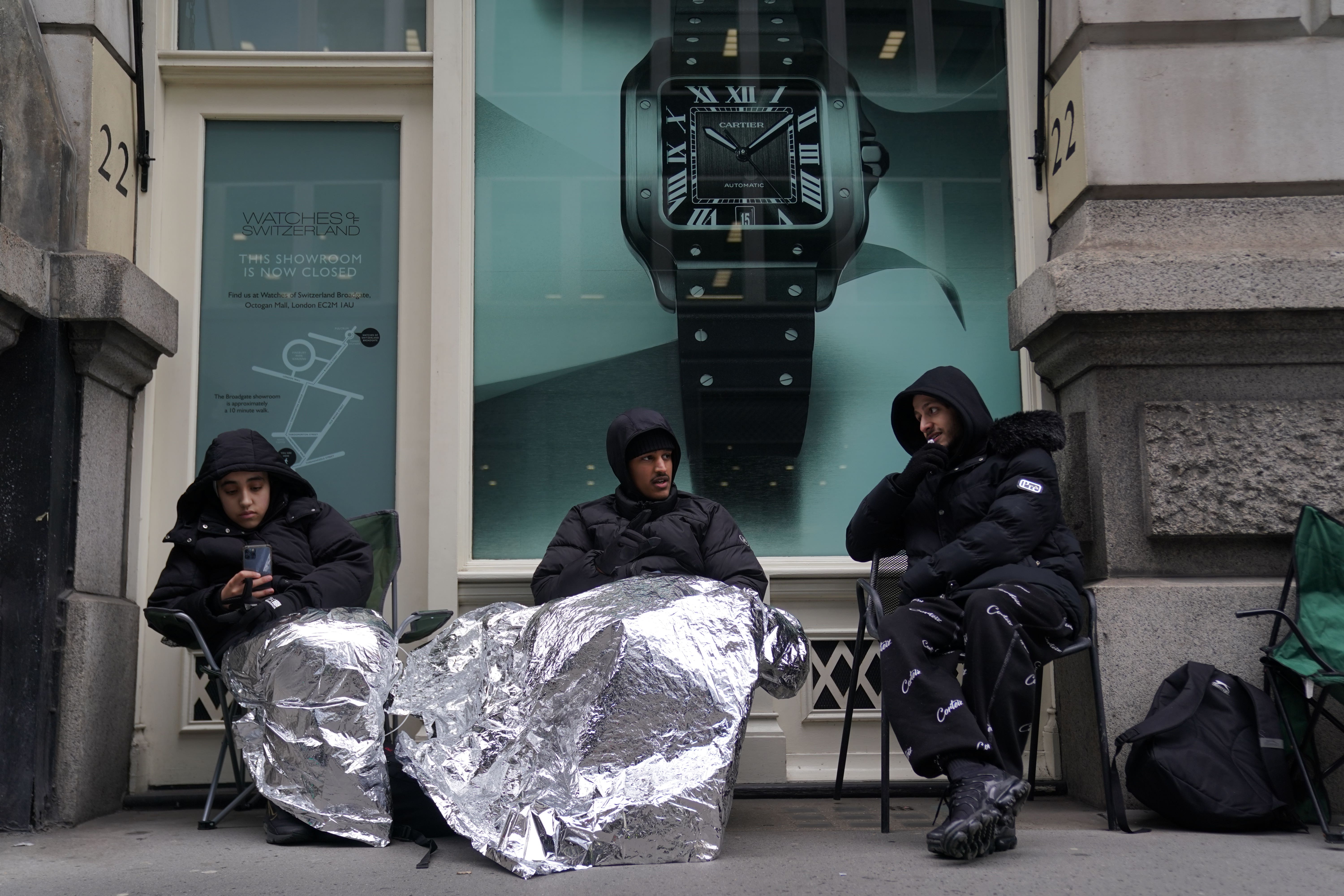 Customers wait in line for the launch of the MoonSwatch at the Swatch store in the Royal Exchange, central London (Kirsty O’Connor/PA)