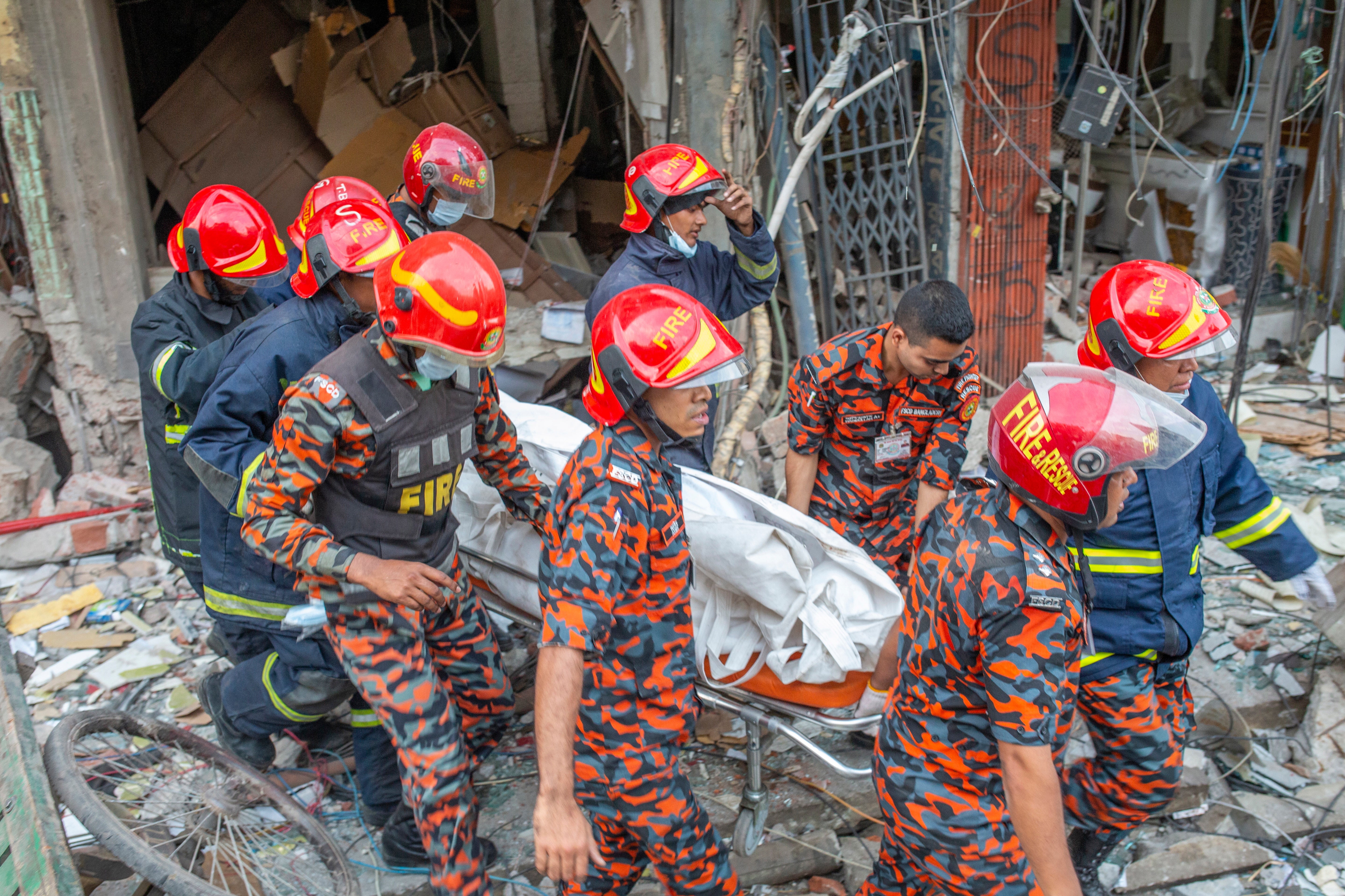 Firefighters shift a body bag of victims after an explosion at Siddique Bazar area in Dhaka, Bangladesh on 7 March
