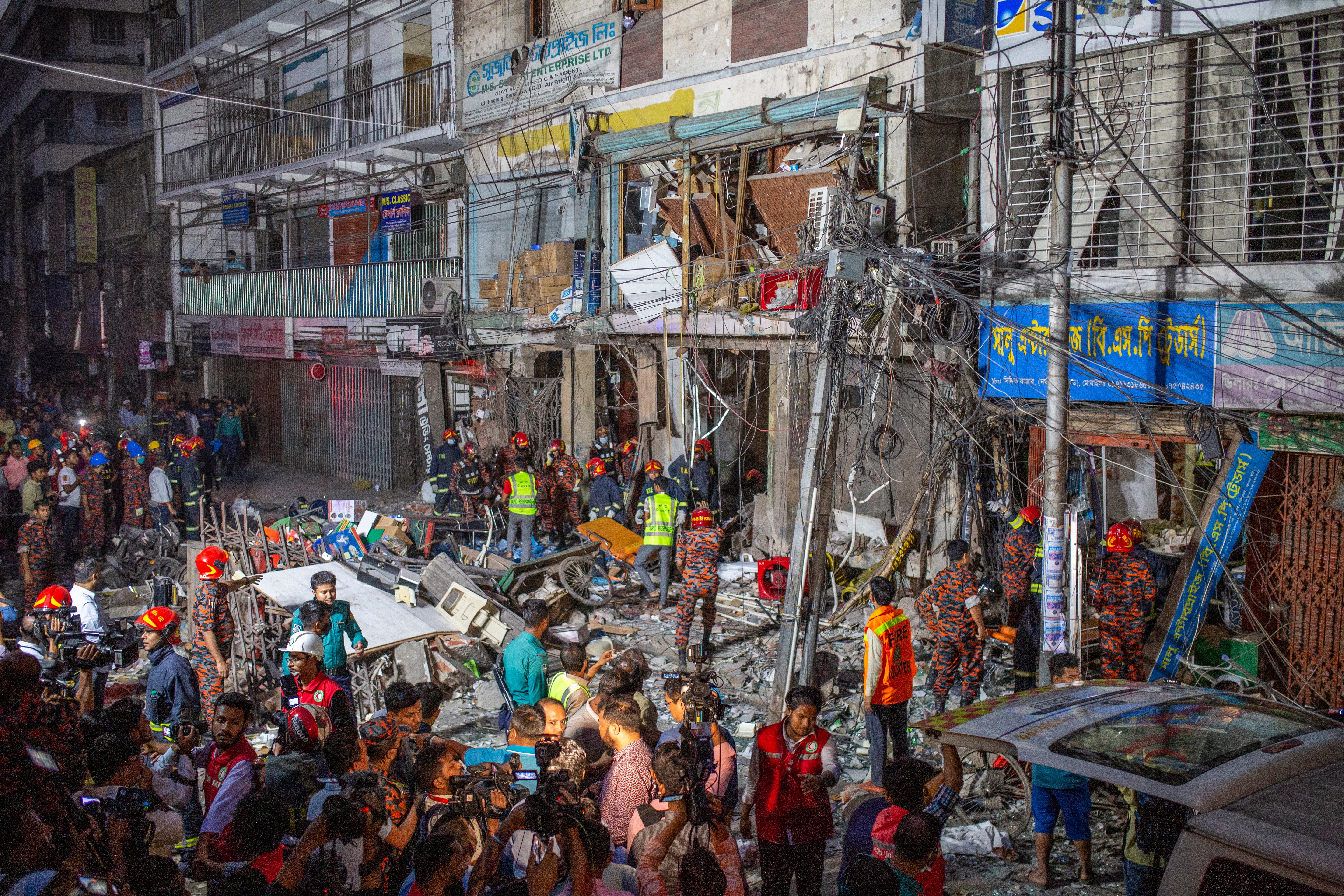 Firefighters inspect the site of an explosion at Siddique Bazar area in Dhaka