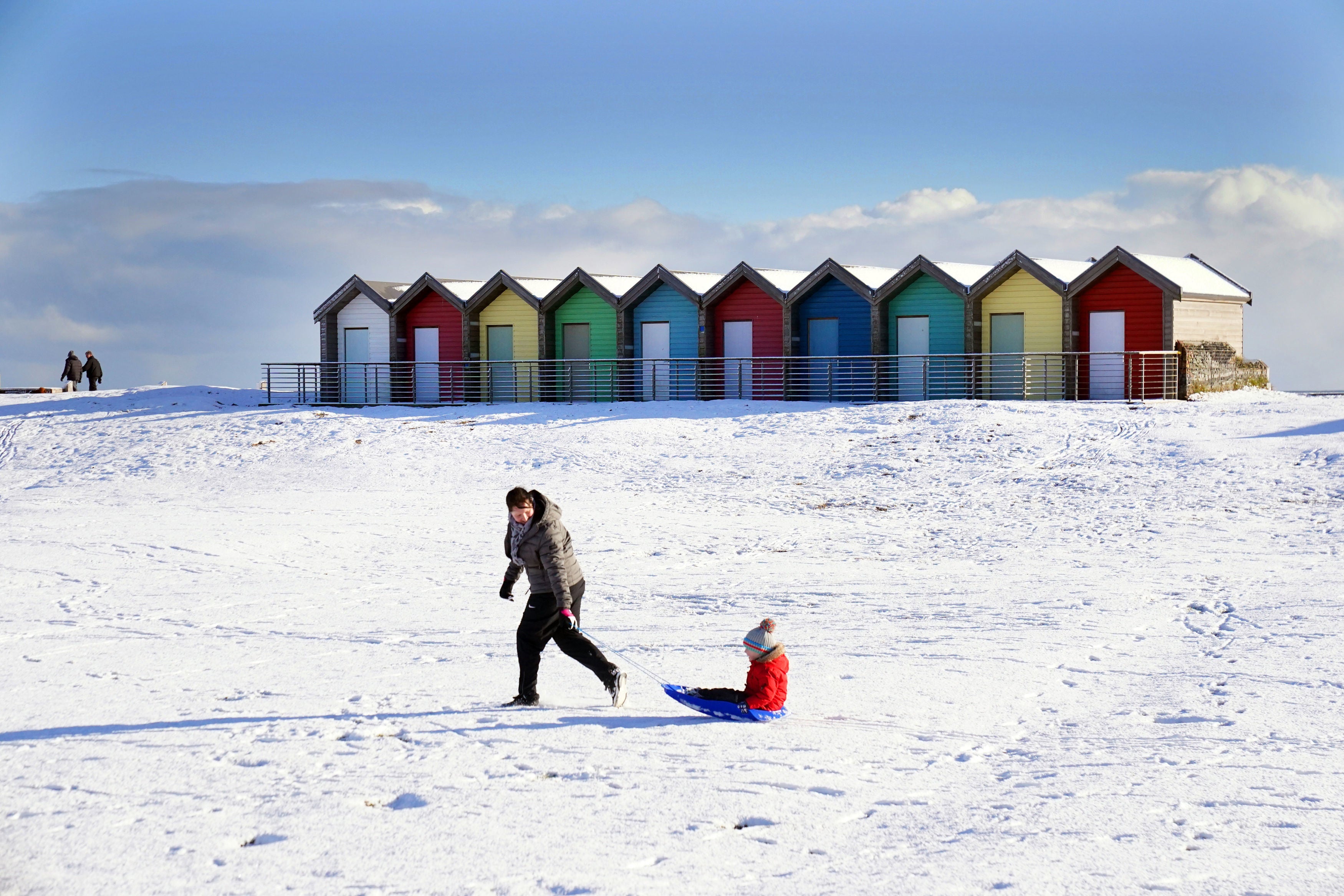 A child is pulled on a sledge at Blyth in Northumberland