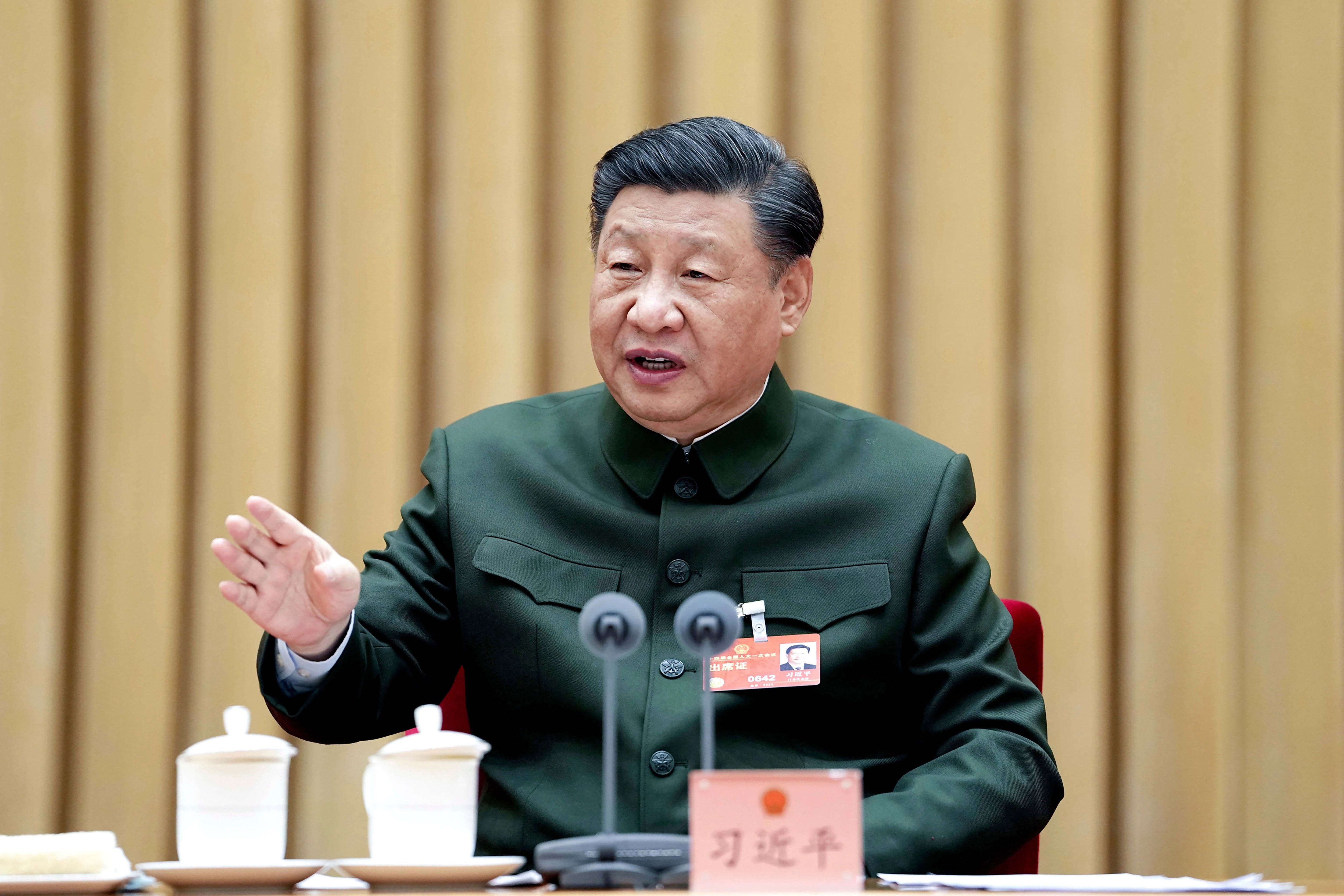 In this photo released by Xinhua News Agency, Chinese president Xi Jinping attends a plenary meeting of the delegation of the People's Liberation Army (PLA) and the People's Armed Police Force during the first session of the 14th National People's Congress (NPC) in Beijing, on Wednesday, 8 March 2023