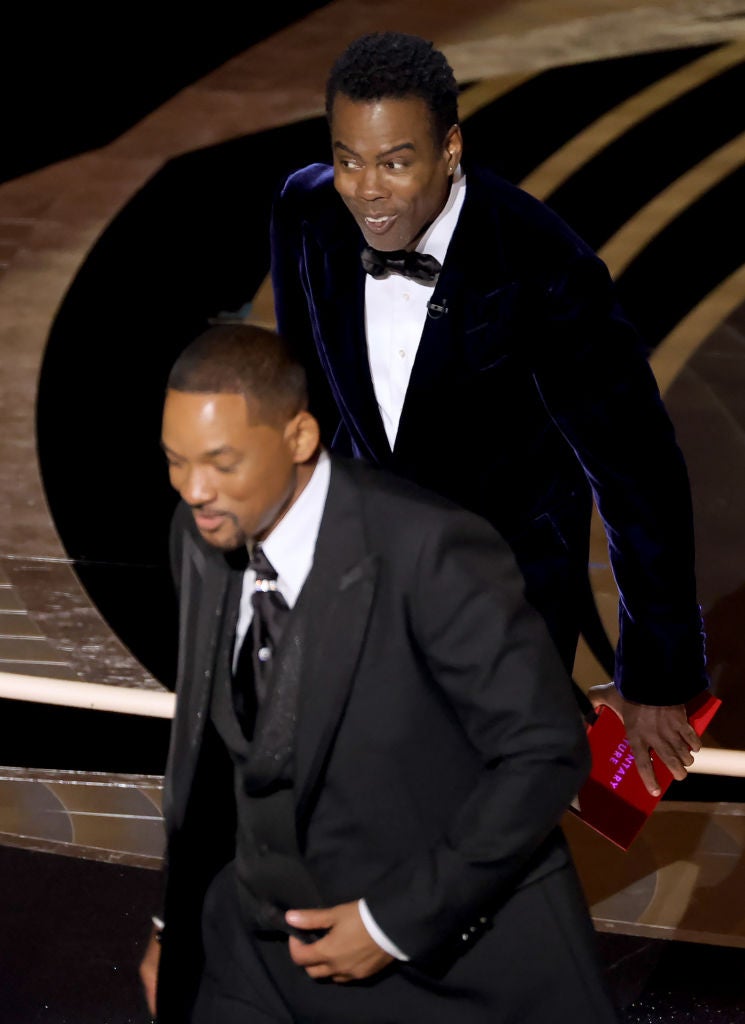 Will Smith walks off after slapping Chris Rock onstage at the Academy Awards in 2022