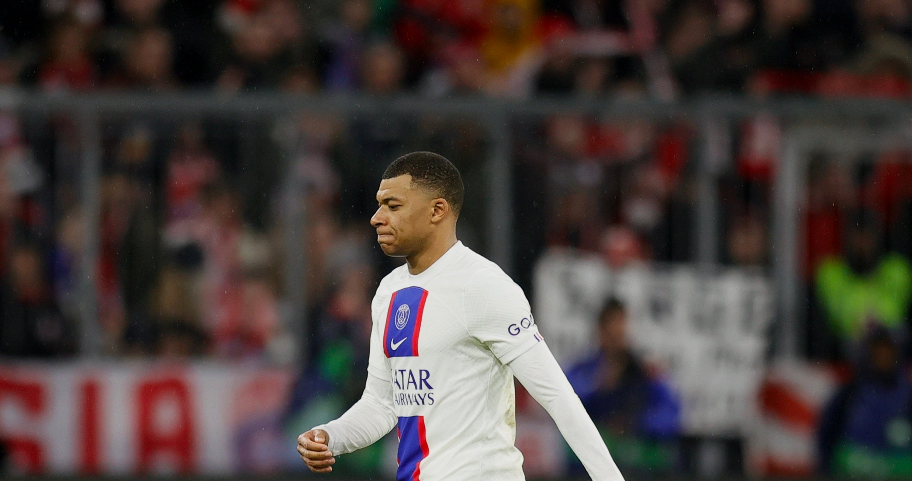 Kylian Mbappe walks off the pitch after defeat by Bayern Munich