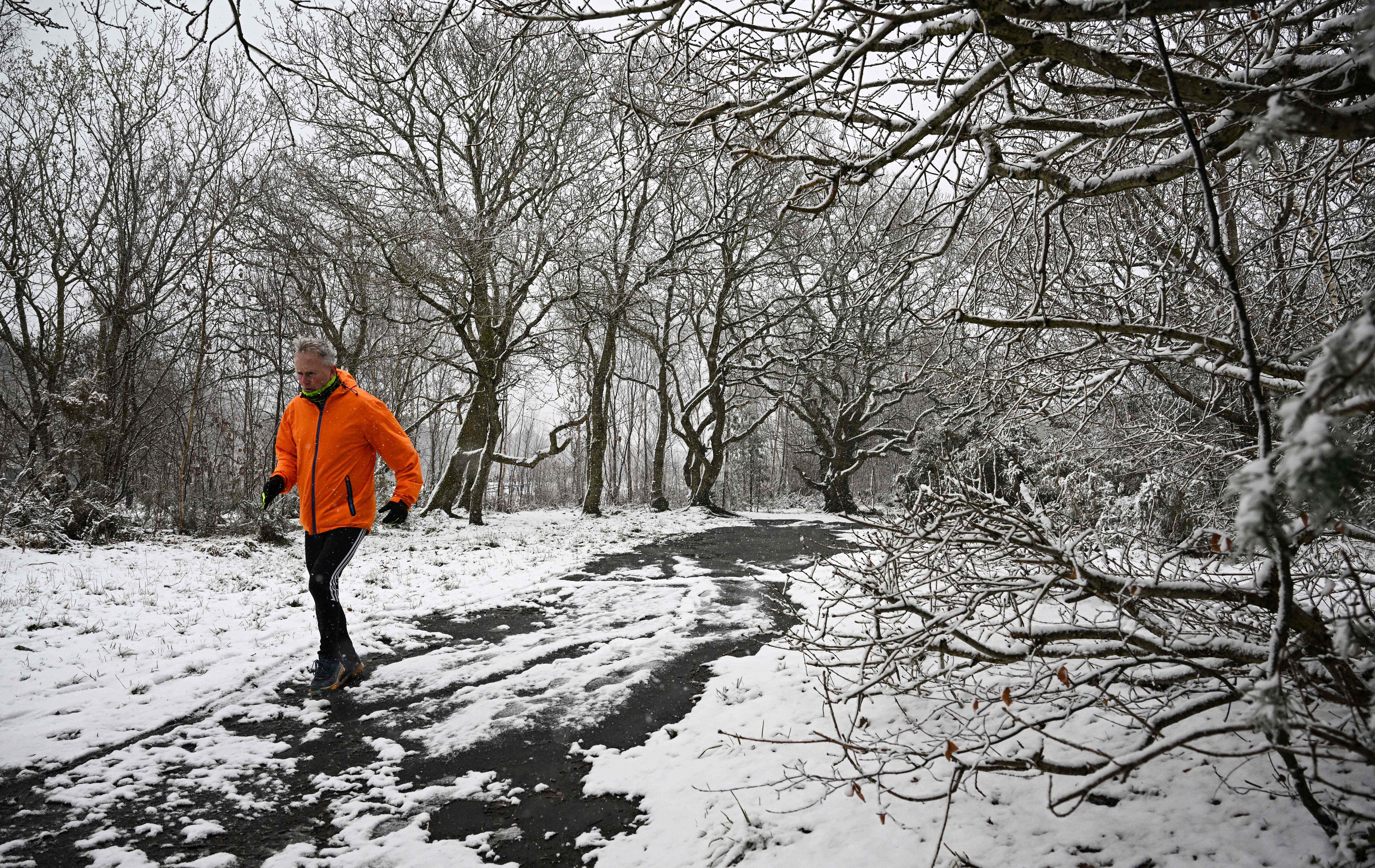 A runner braves the snow on Bidston Hill, near Birkenhead, in north west England on March 9, 2023