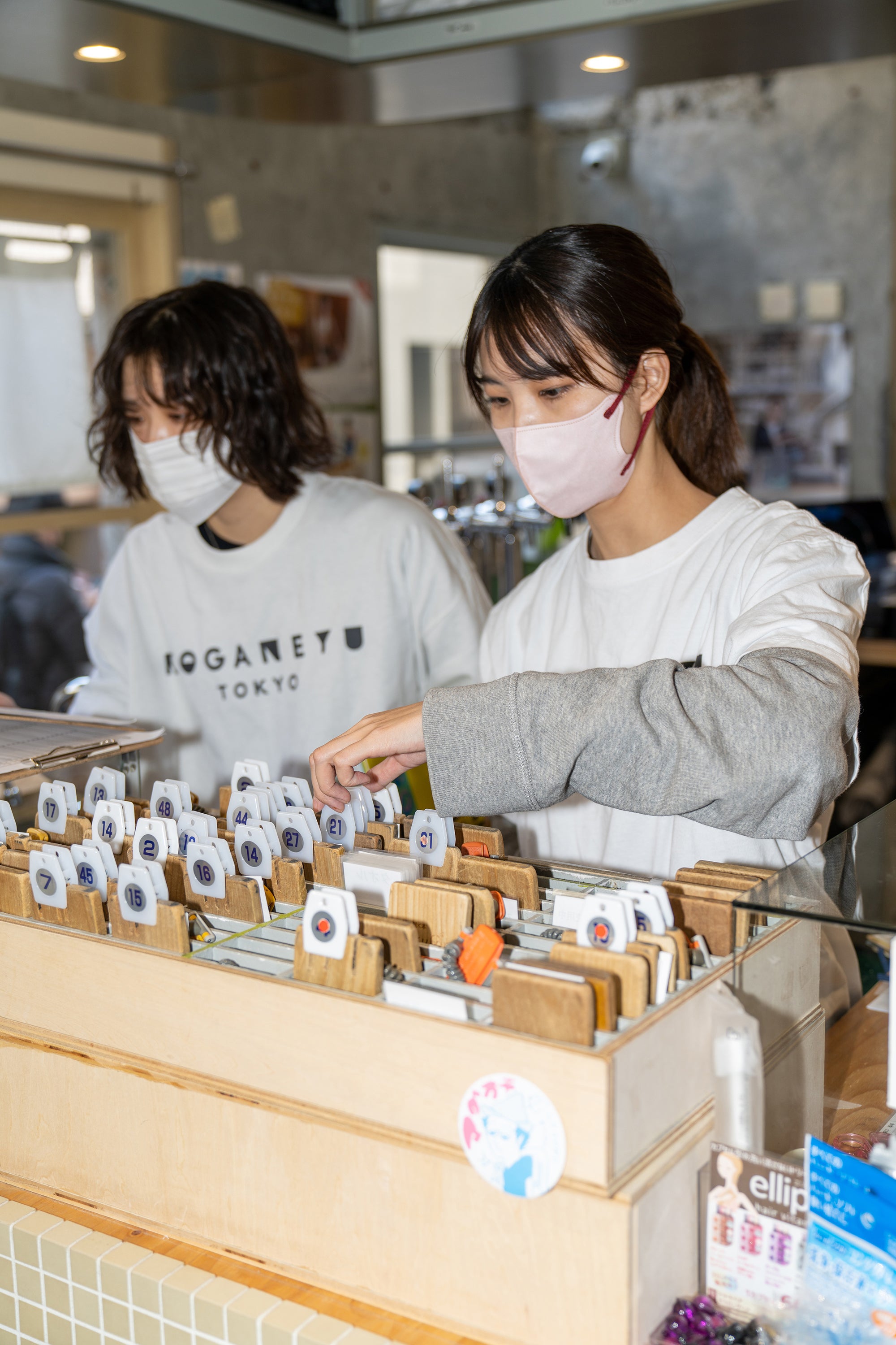 Workers at Koganeyu bathhouse in Tokyo