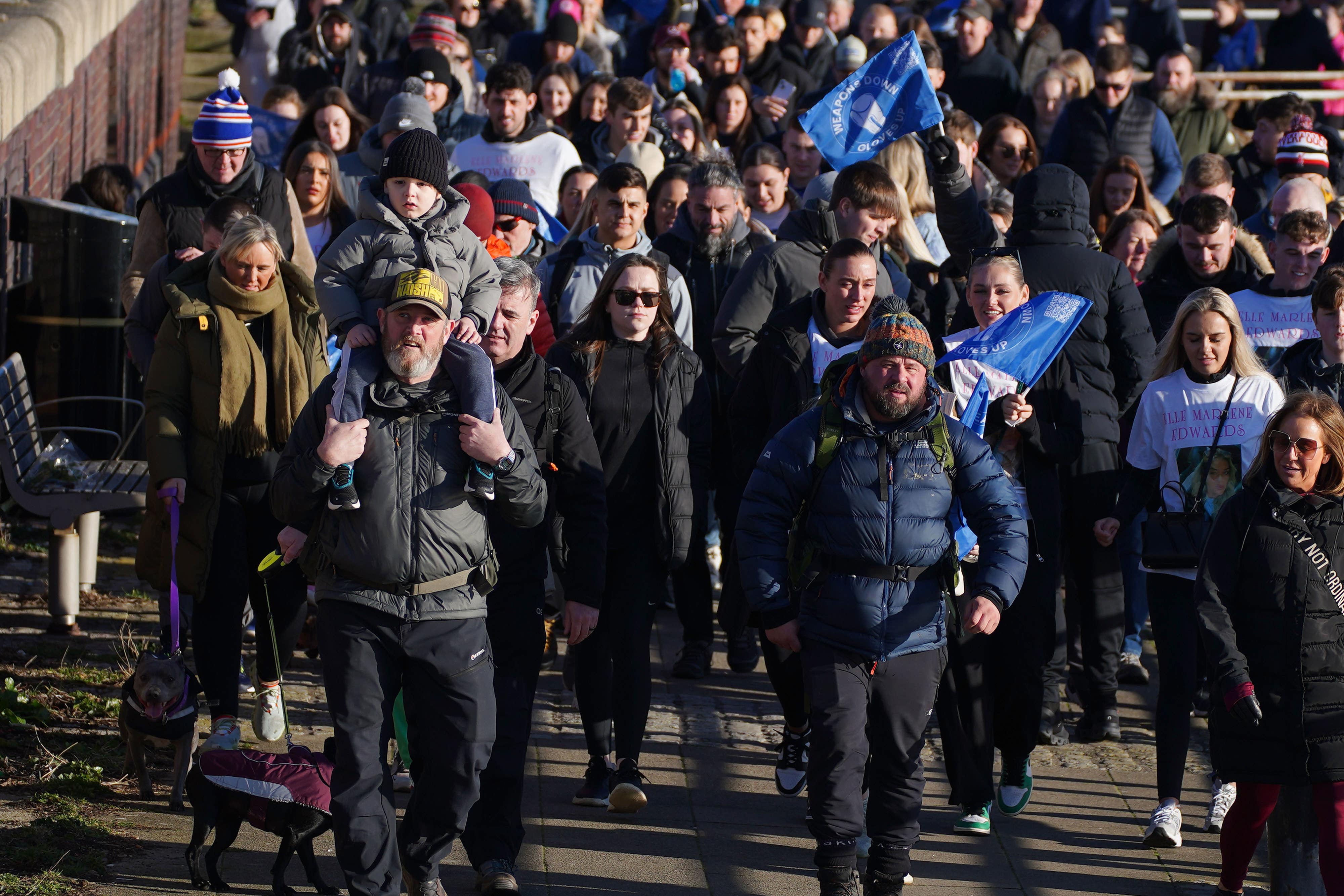 Tim Edwards, the father of murdered Elle Edwards, (centre left) with grandson Ronan on his shoulders with comedian John May (centre right) in Liverpool on a walk from Land’s End to John O’Groats to raise awareness for the Weapons Down Gloves Up scheme – a boxing initiative aimed at taking young people off the streets and into employment (Peter Byrne/PA)