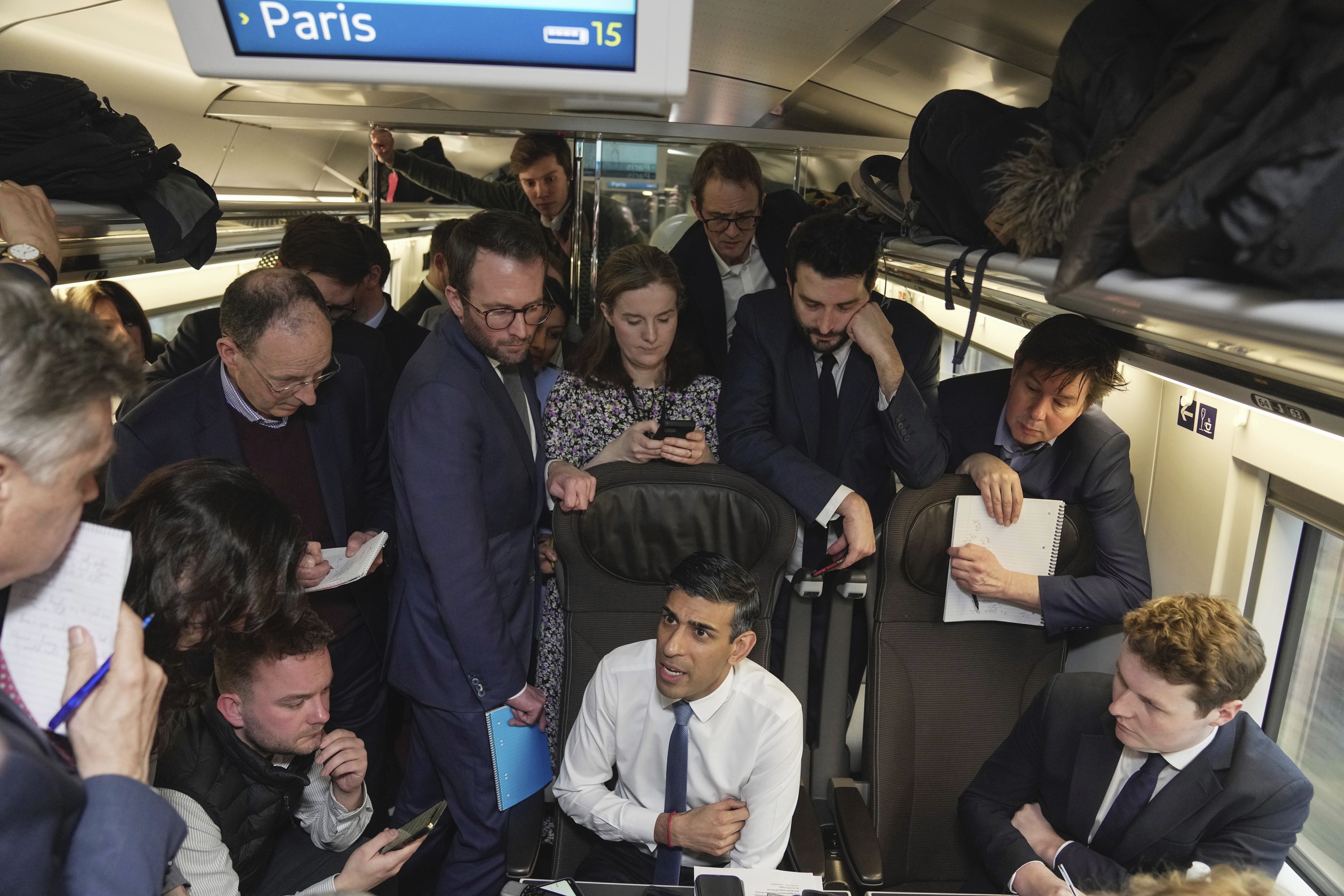 Prime Minister Rishi Sunak (centre) talks to travelling media (Kin Cheung/PA)