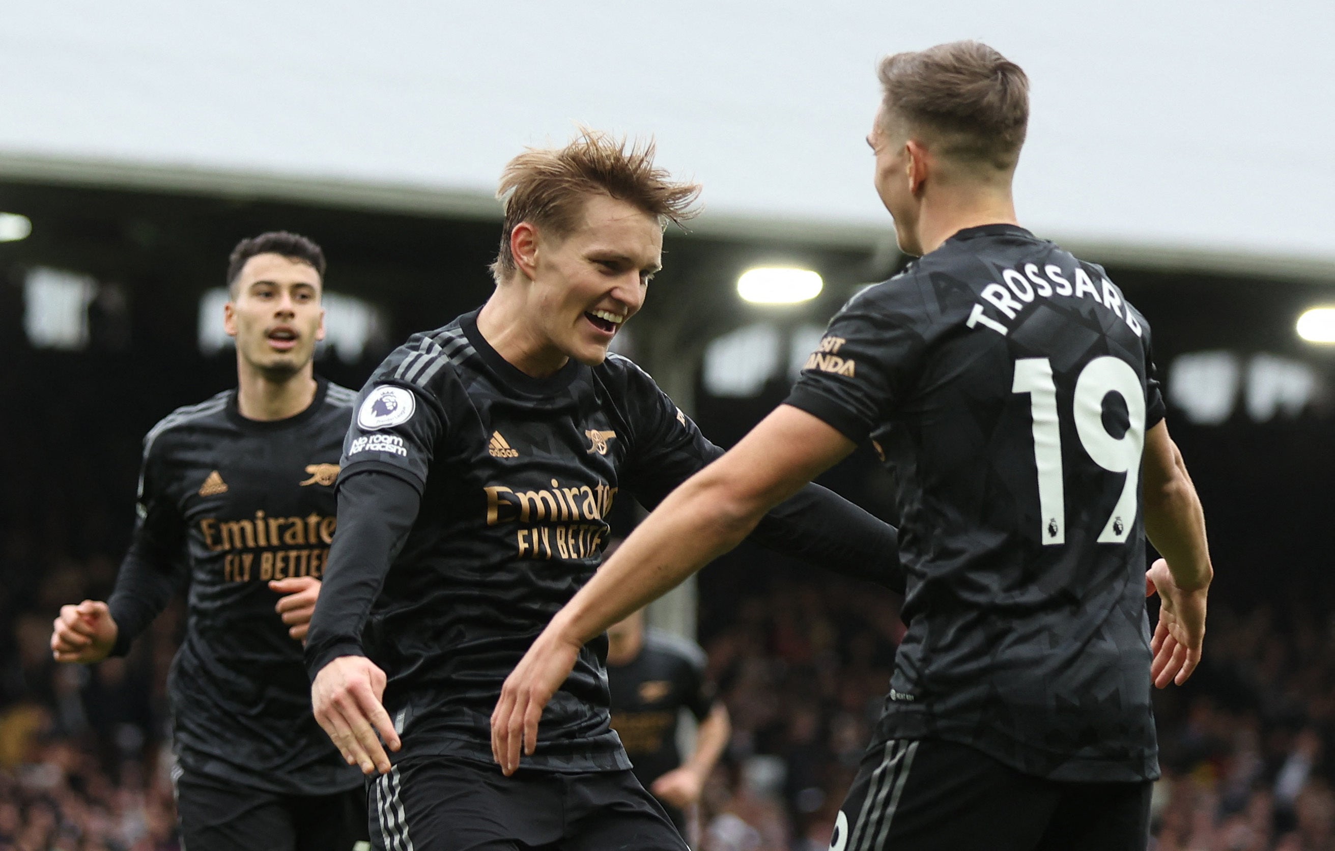 Arsenal celebrate scoring their third goal against Fulham