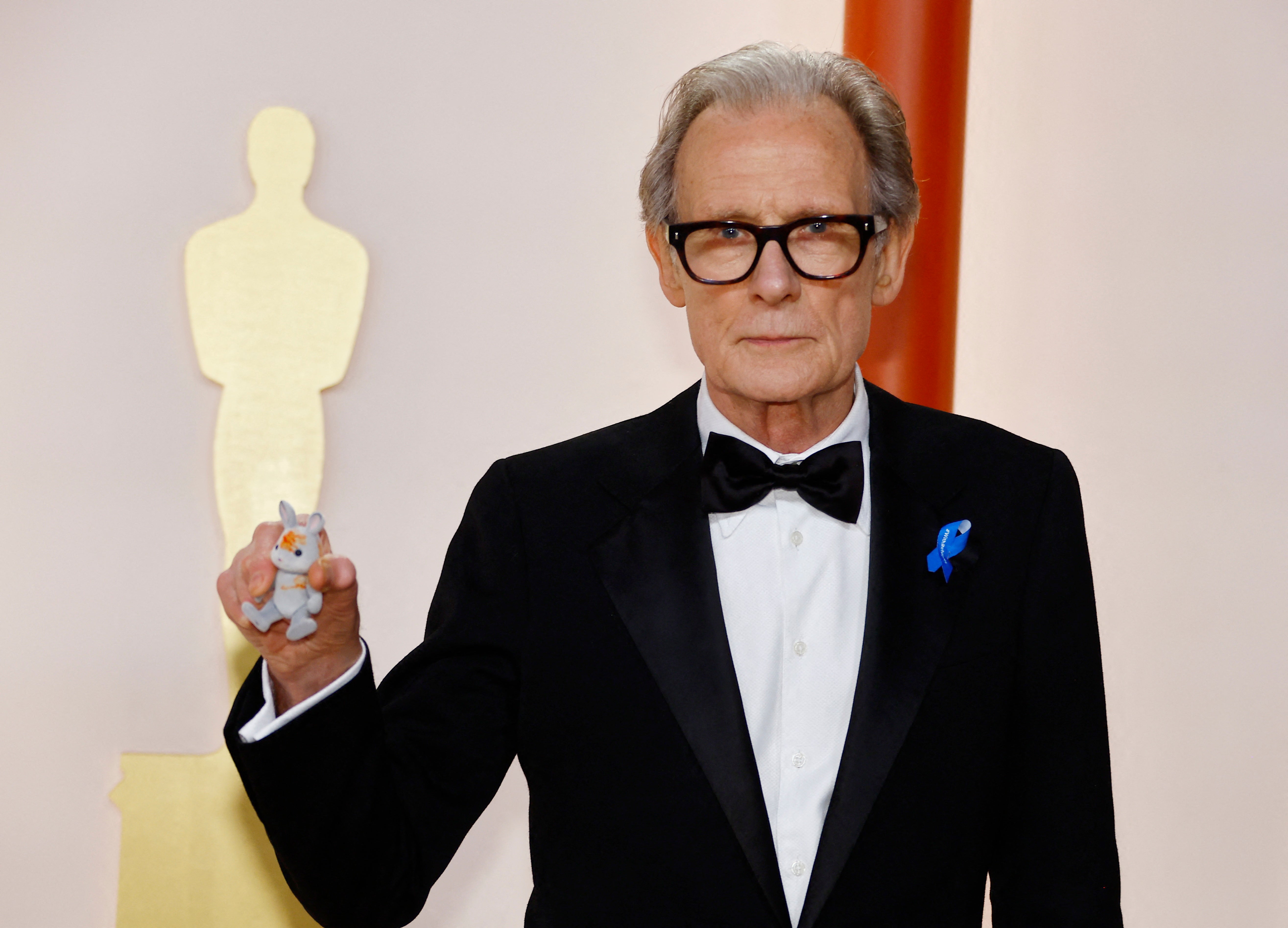 Bill Nighy poses with his grandaughters Sylvanian rabbit at the Oscars