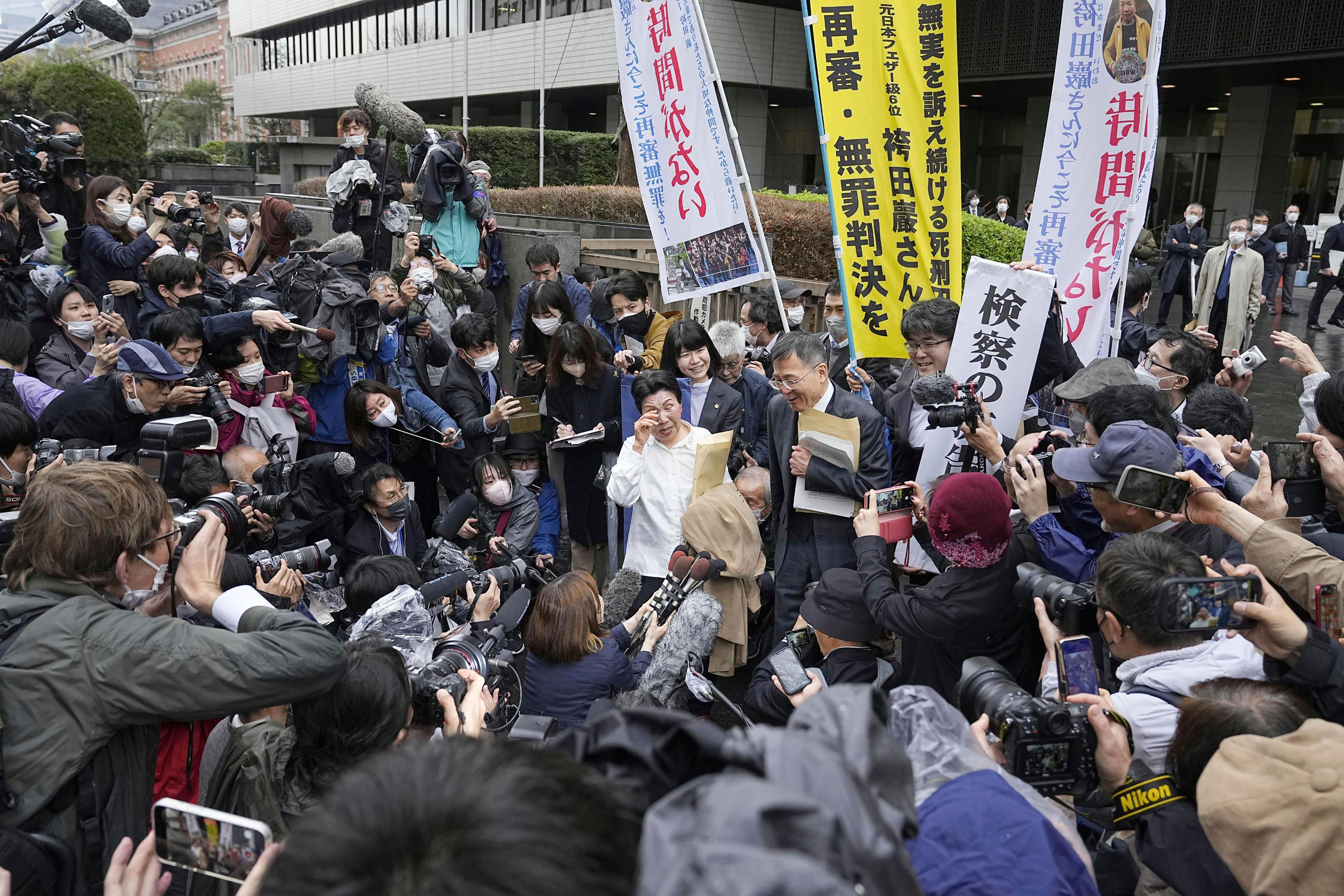 Hideko Hakamada, center left in white cloth, sister of Iwao Hakamada, is surrounded by media