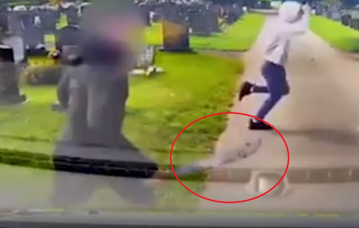 Man carries machete amid cemetry brawl