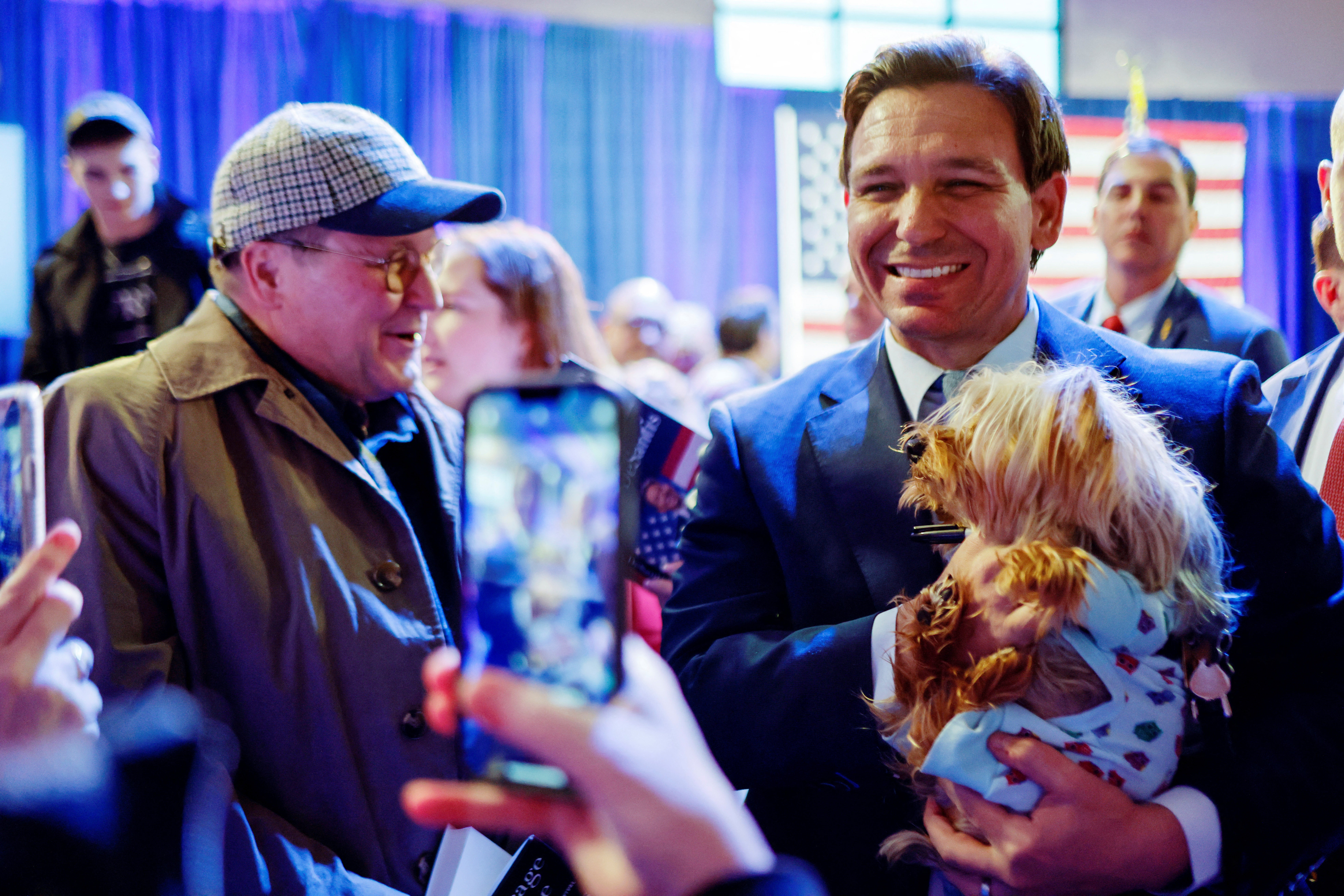 Florida Governor Ron DeSantis holds Wyley the dog posing for pictures as he makes his first trip to the early voting state of Iowa for a book tour stop at the Iowa State Fairgrounds in Des Moines, Iowa, U.S. March 10, 2023