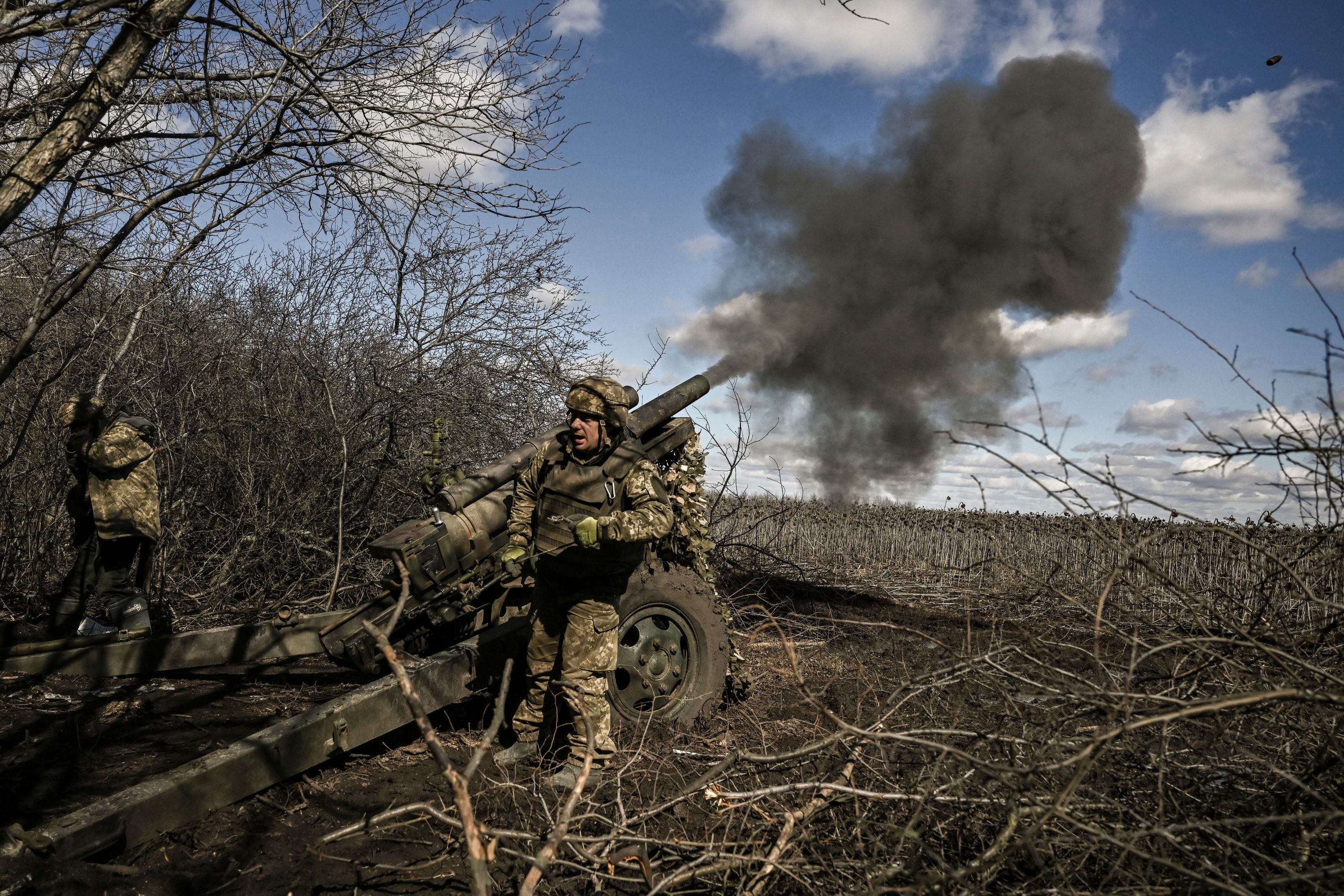 Ukrainian servicemen fire at Russian positions with a 105mm howitzer in the region of Donbas