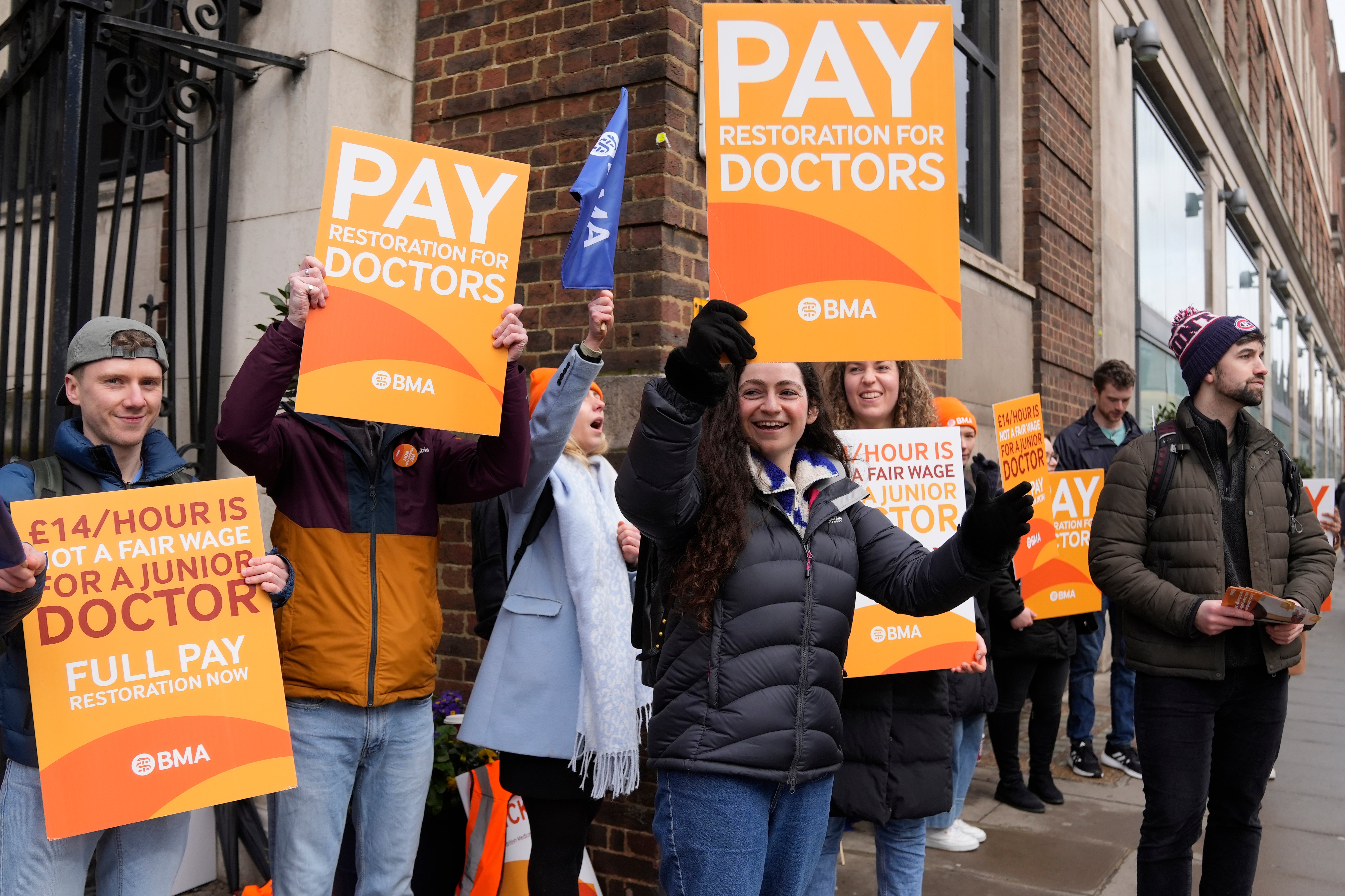 Junior doctors hold placards on a picket line outside St Mary's Hospital in London on Tuesday