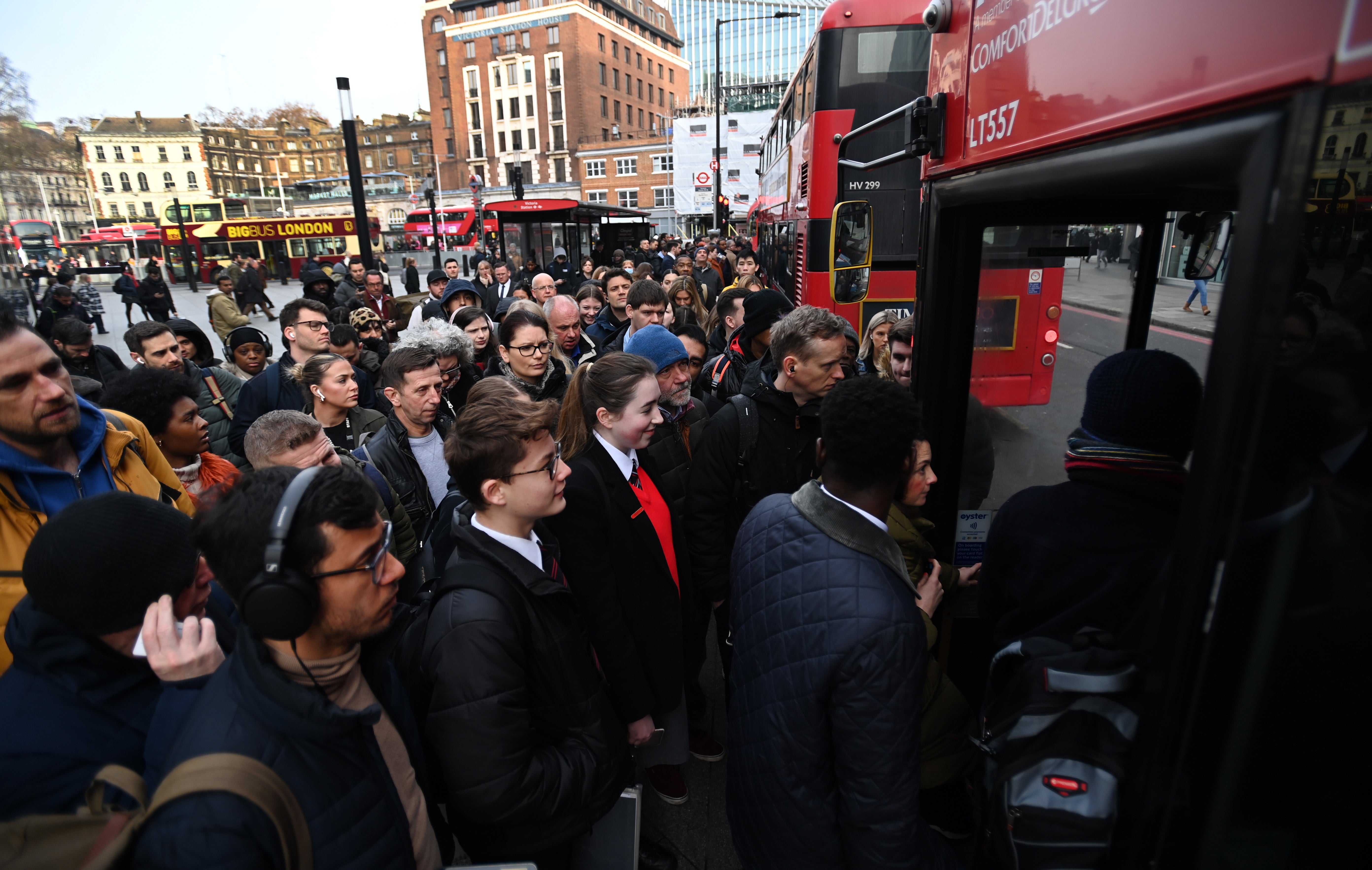 People queue for buses outside Victoria station in London on Wednesday 15 March 2023