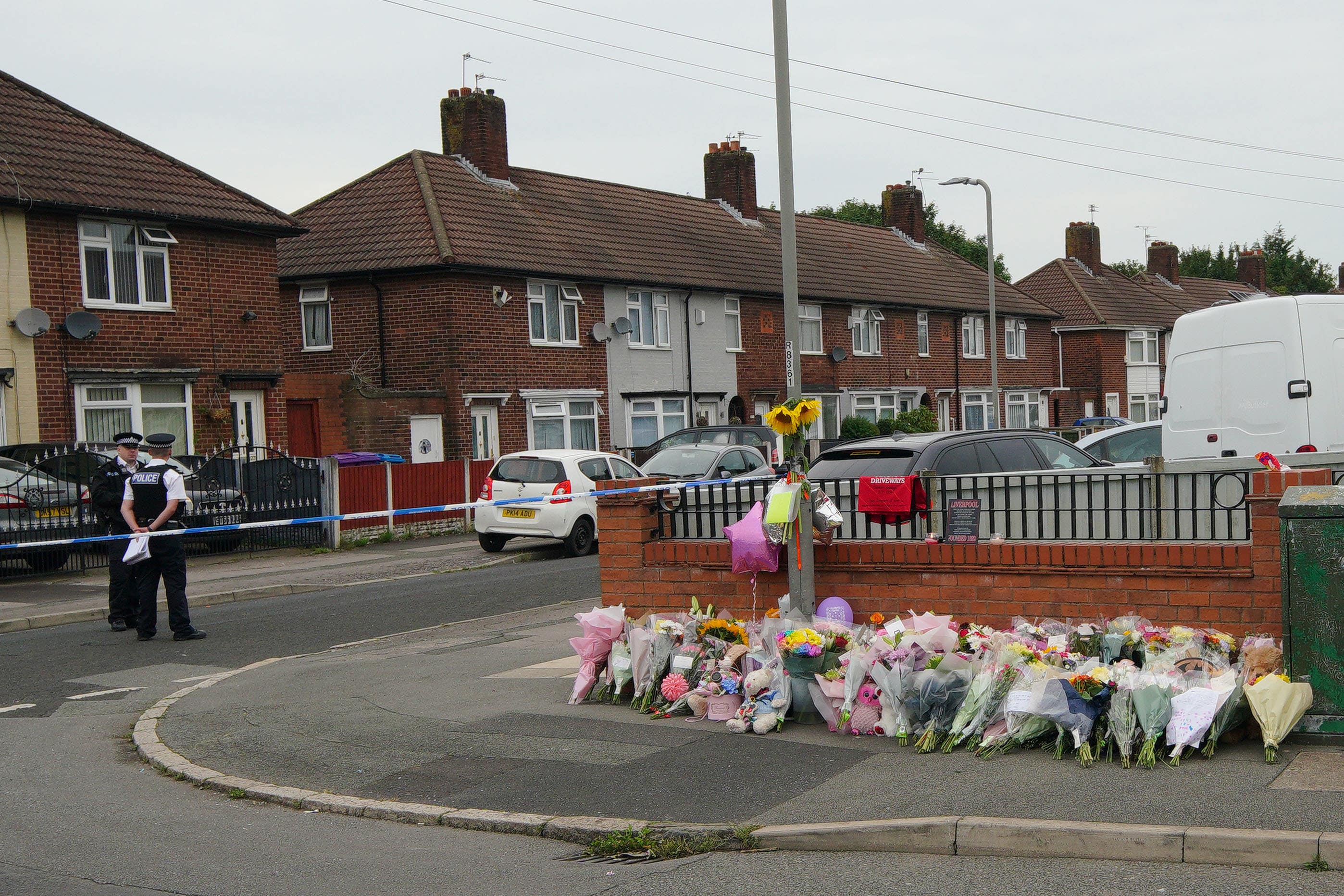 Flowers are left on Kingsheath Avenue after Olivia Pratt-Korbel was killed (Peter Byrne/PA)