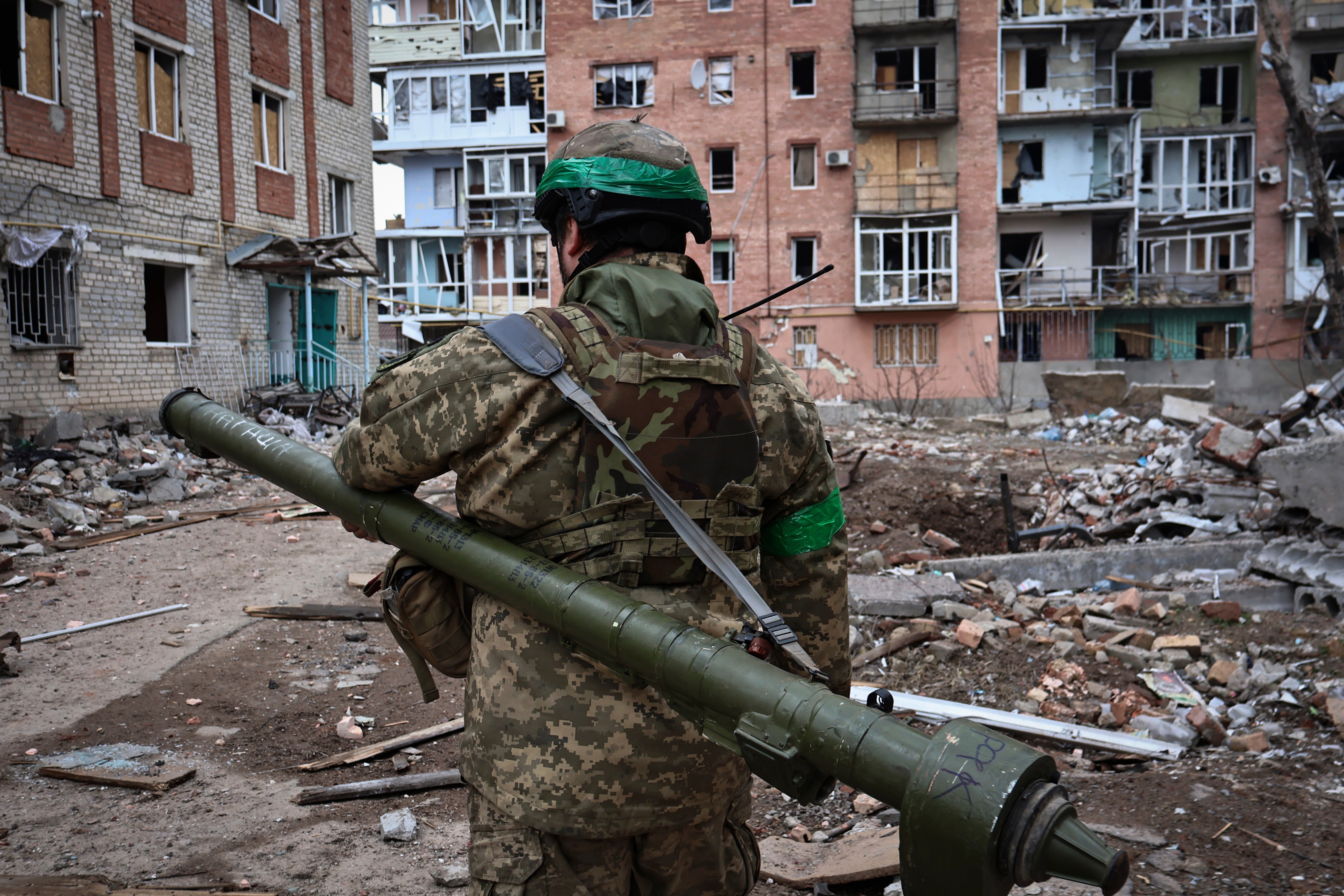 A Ukrainian soldier carries a portable anti-aircraft missile system in Bakhmut