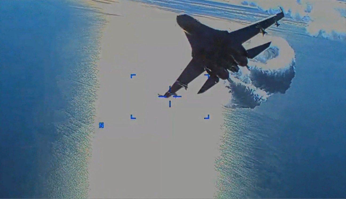 A Russian Su-27 aircraft dumps fuel while flying by a US Air Force intelligence drone