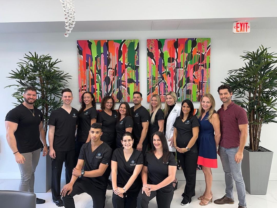 Marjanovic is pictured (left) with the staff of his clinic