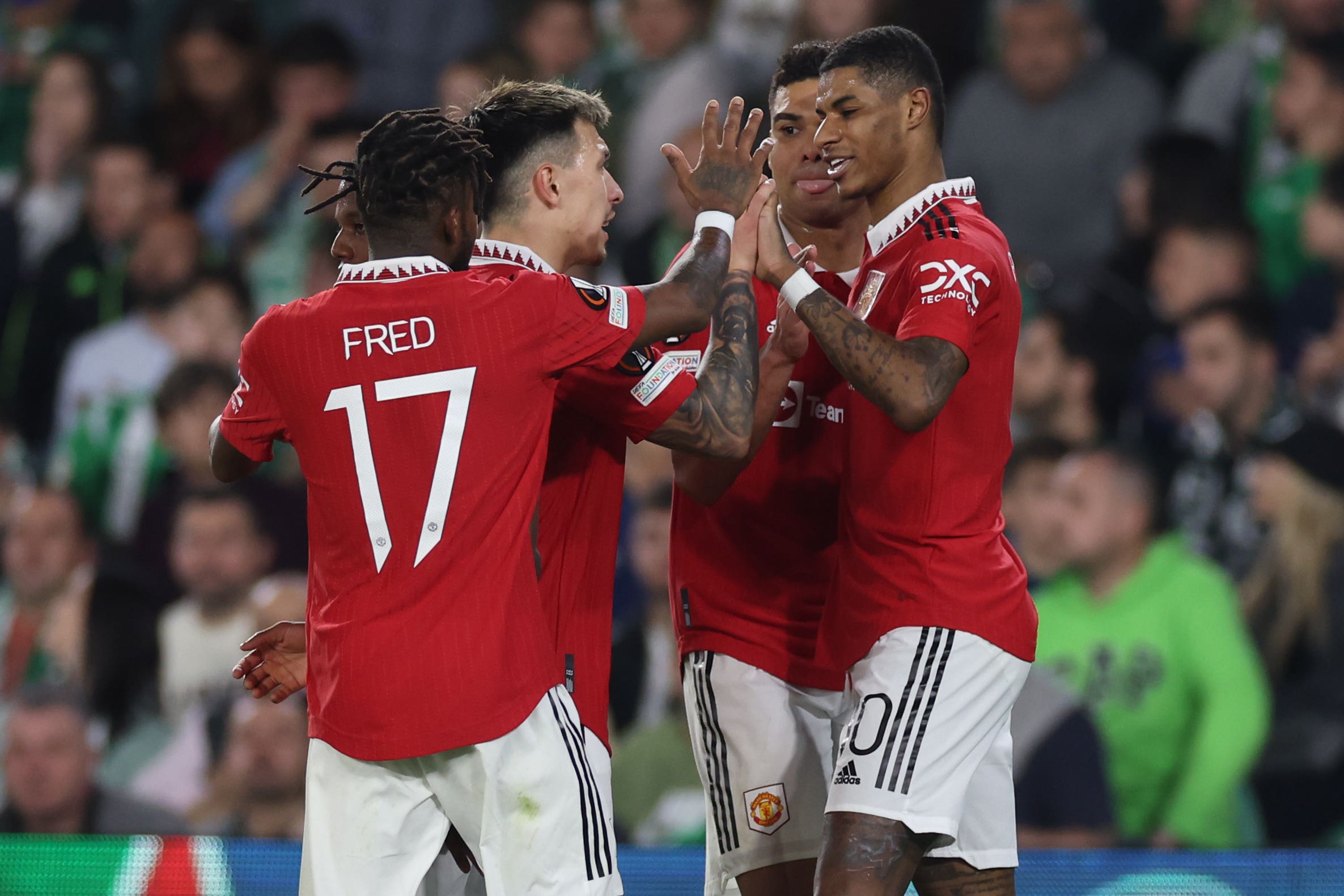 Marcus Rashford celebrates with teammates after his goal won the game for United