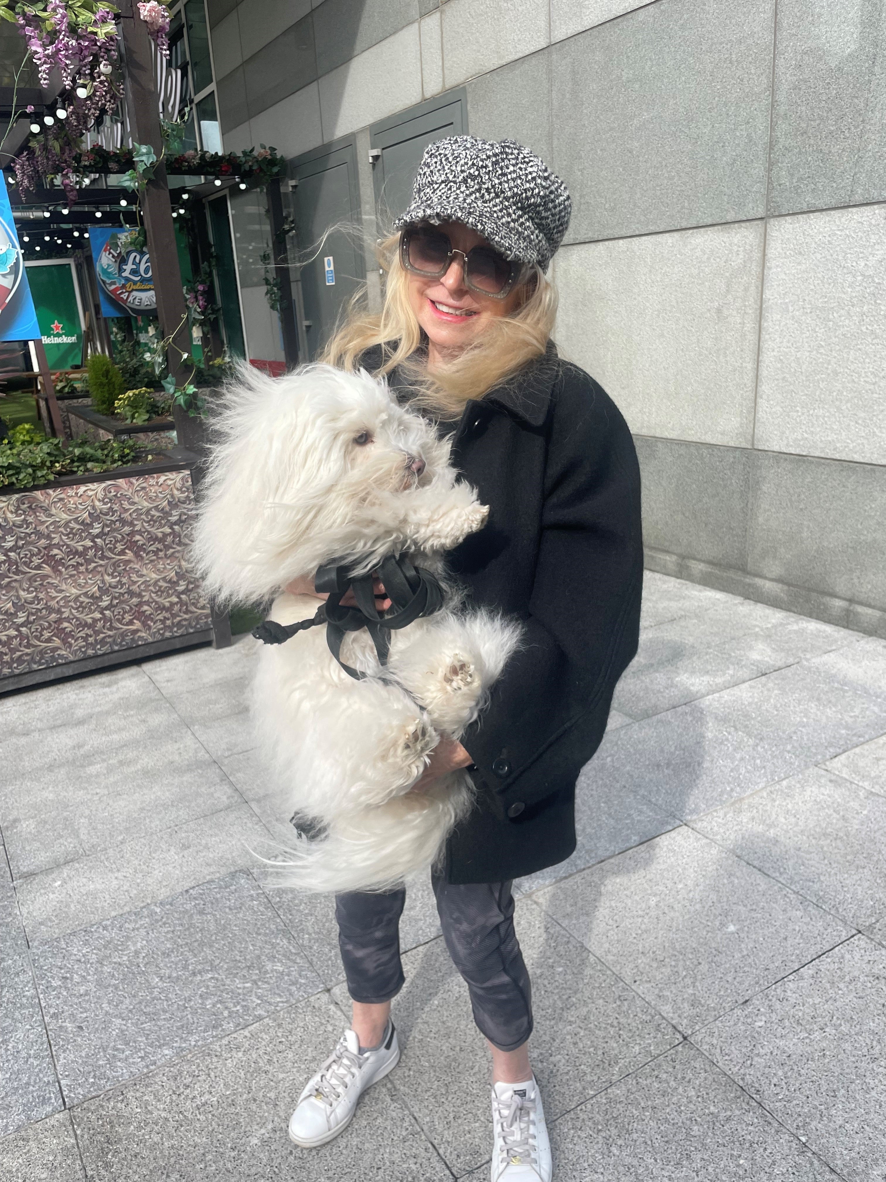 Standing outside a Waitrose and Partners store with her dog is Barbara Baldwin, who works in the stock market