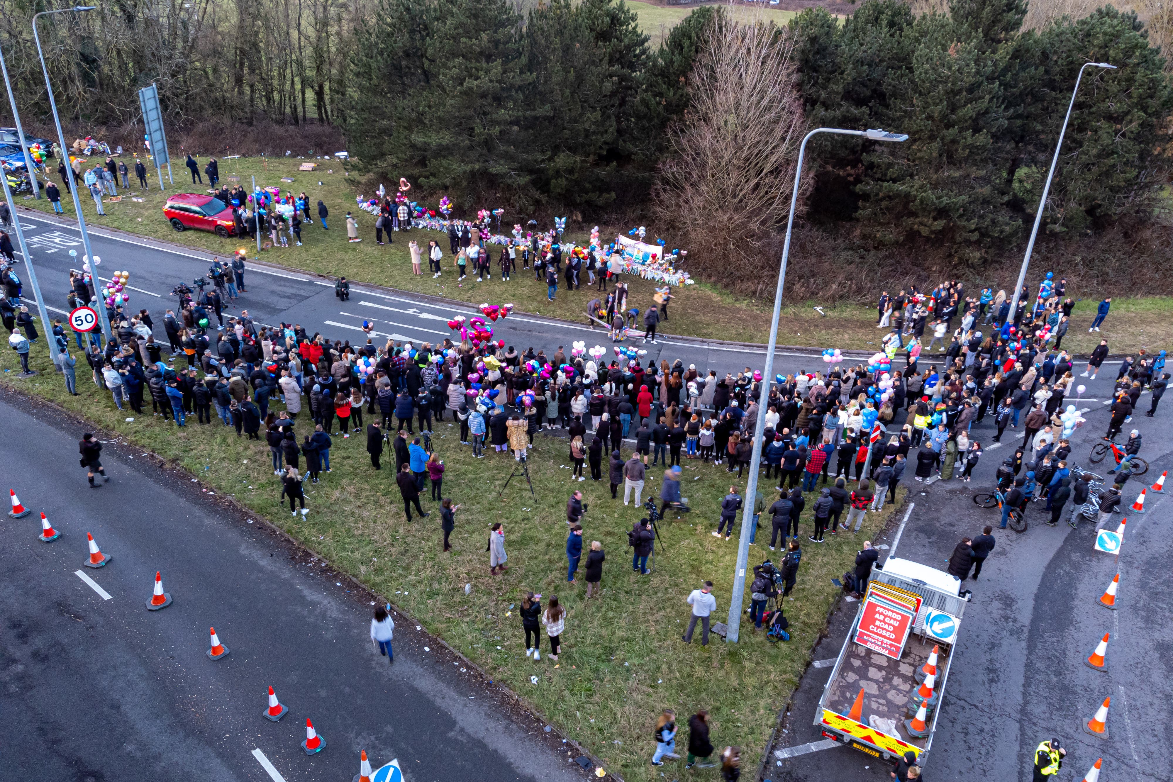 People attend a vigil in the St Mellons area of Cardiff, in memory of Eve Smith, 21, Darcy Ross, 21, and Rafel Jeanne, 24 (Ben Birchall/PA)