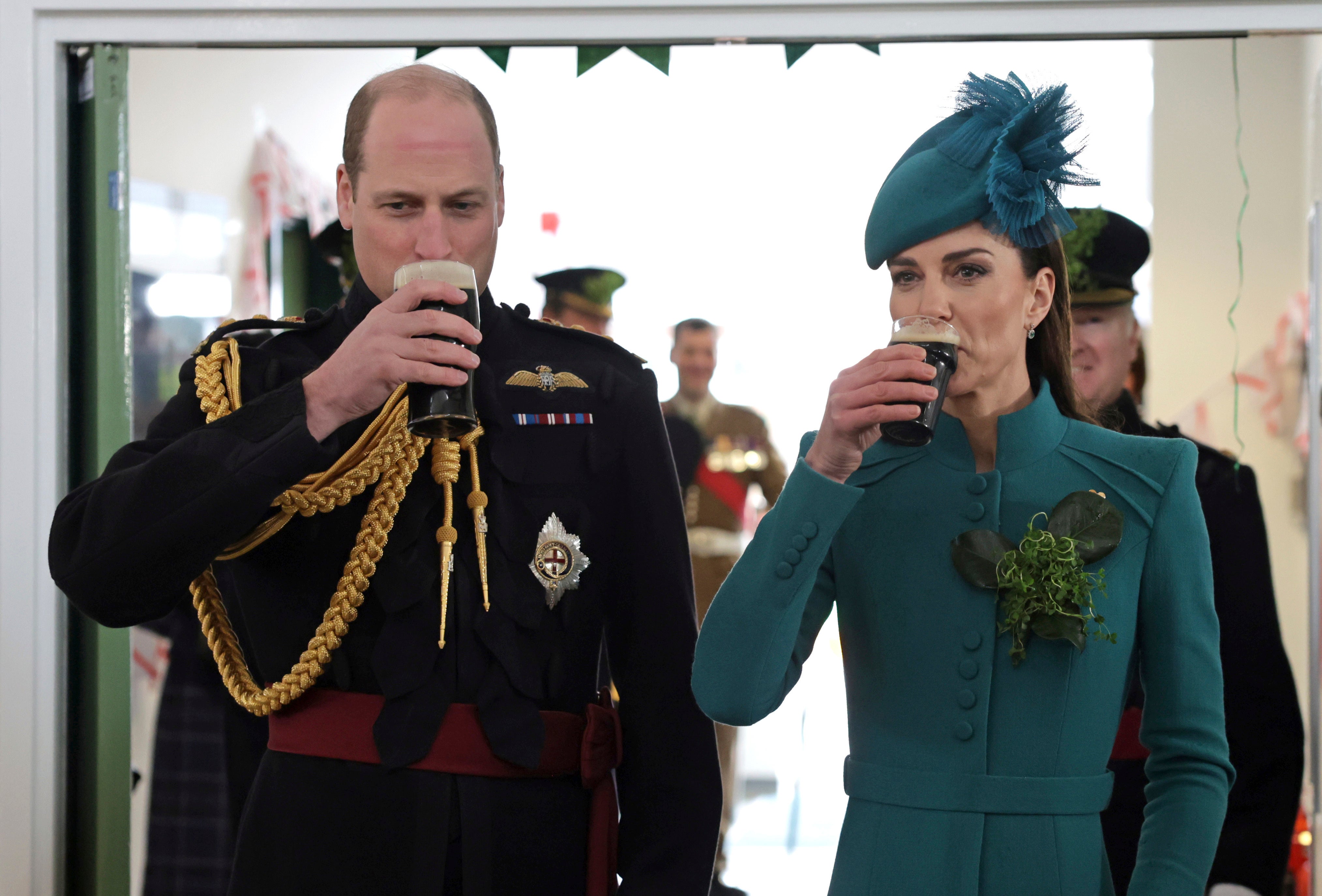 Prince William, the Prince of Wales and Kate, the Princess of Wales drink Guinness, during the St. Patrick's Day Parade at Mons Barracks, in Aldershot, England, Friday, March 17, 2023