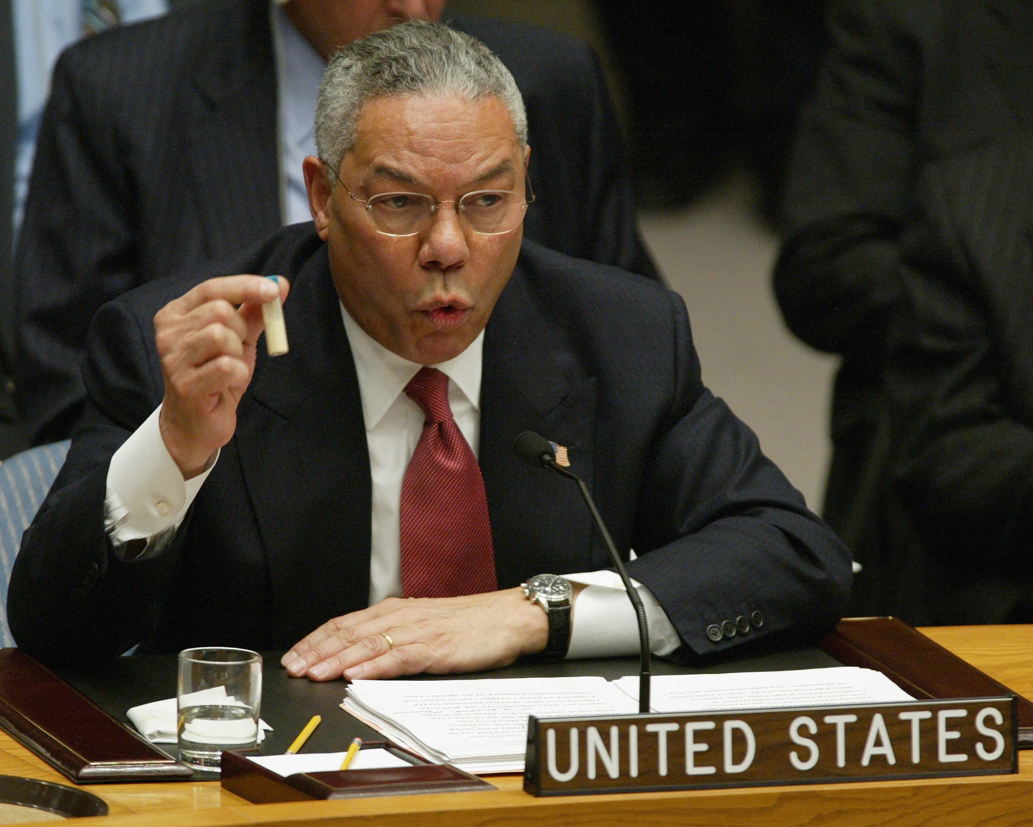 US secretary of state Colin Powell holds up a vial that he said was the size that could be used to hold anthrax, as he addresses the United Nations Security Council on 5 February 2003