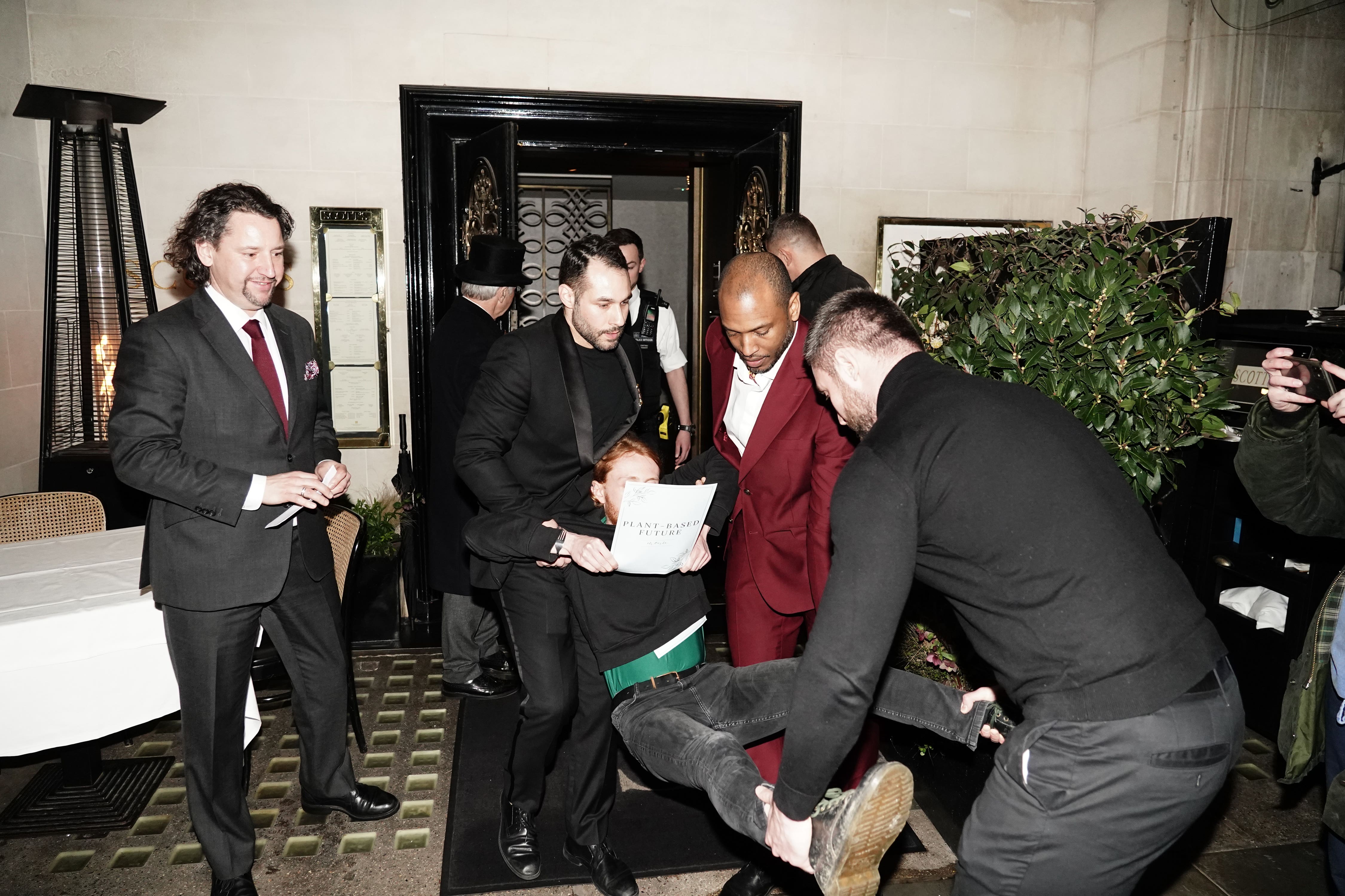 Police officers were present as protesters were seen being carried out of the restaurant (Jordan Pettitt/PA)