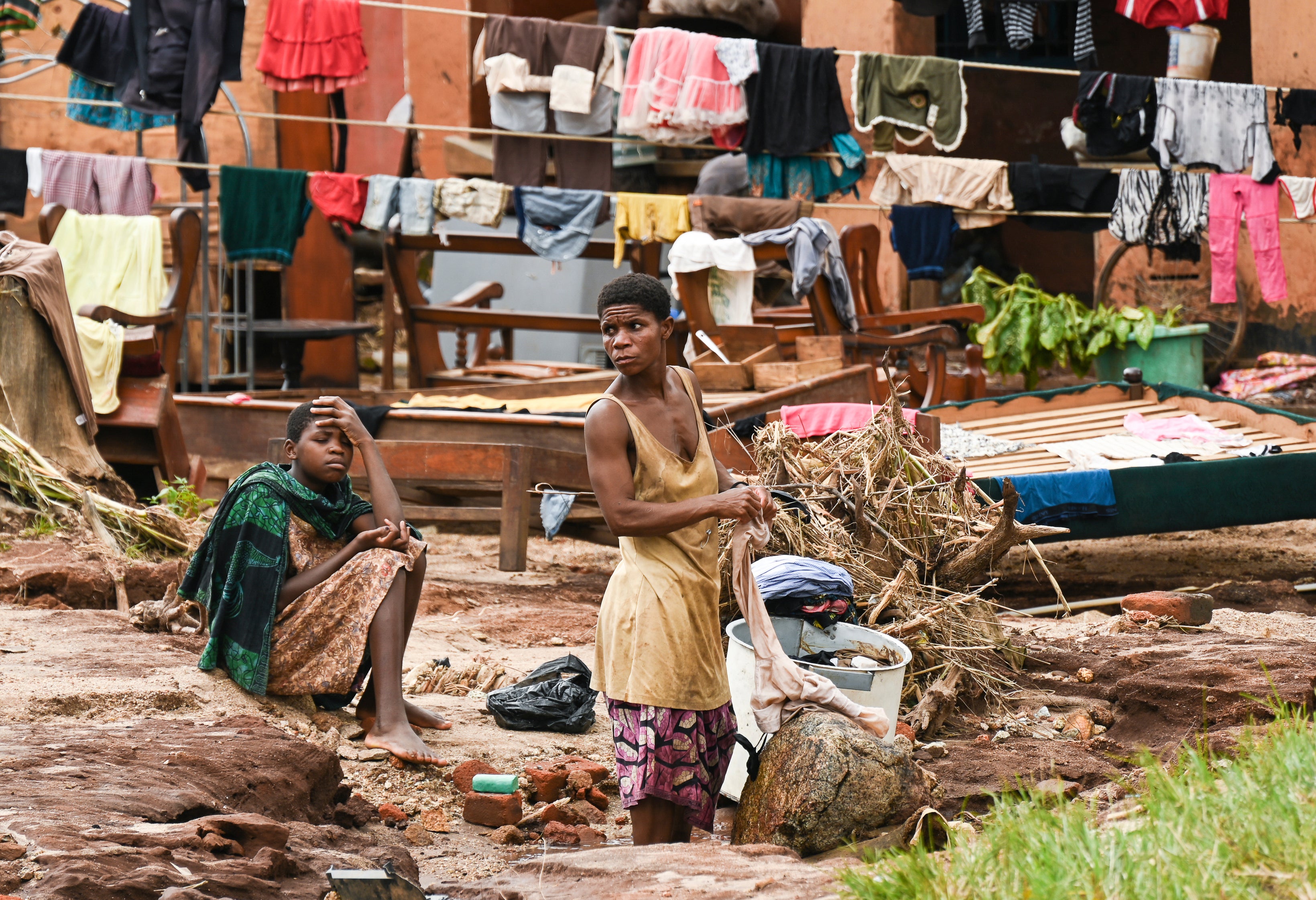 Clothes are hung out to dry on called electrical power lines caused by last week's heavy rains caused by Tropical Cyclone Freddy in Phalombe, southern Malawi