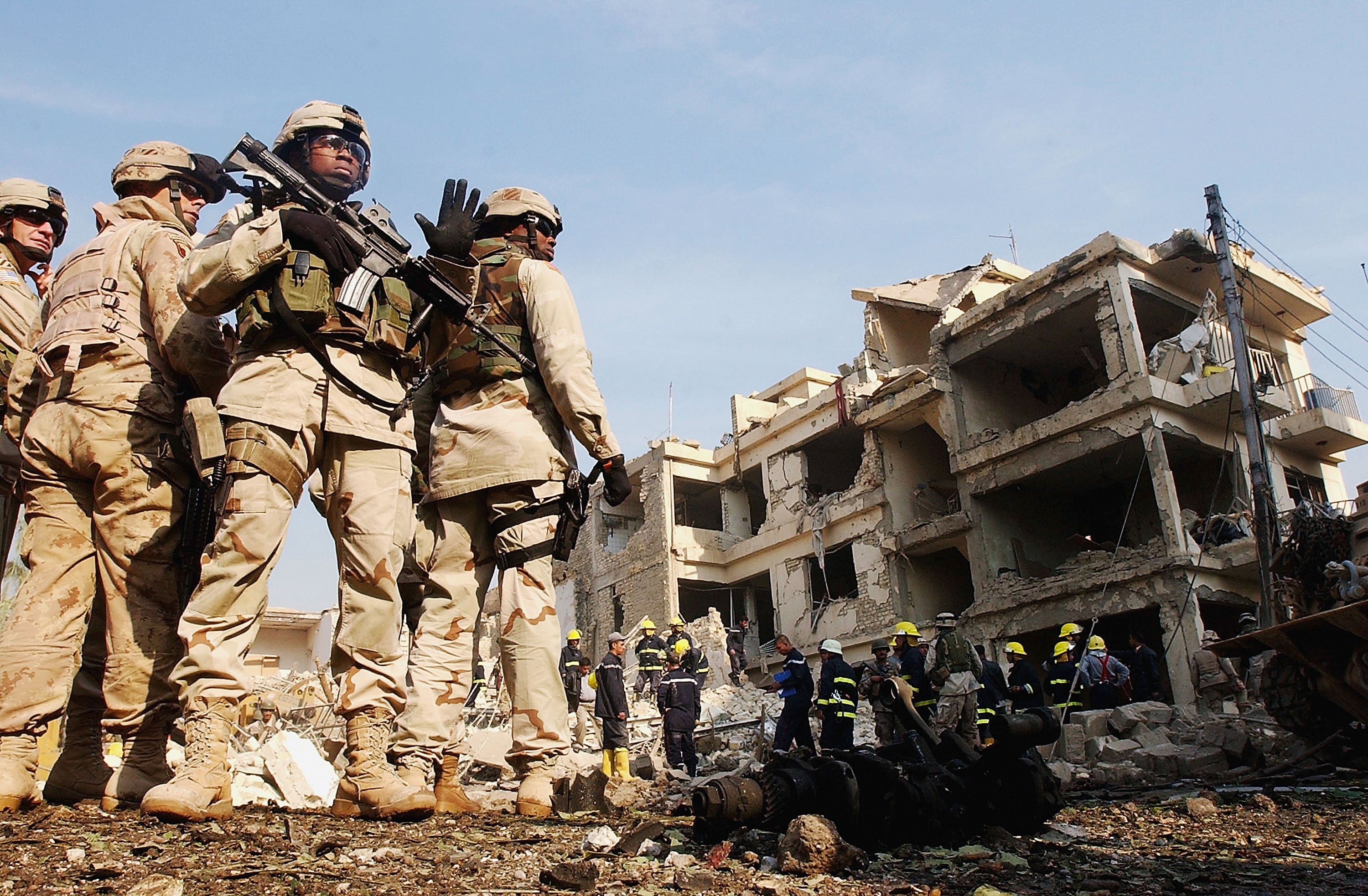 US soldiers secure the area where two suicide car bombs exploded near the Hamra Hotel which was being used by foreign workers and journalists