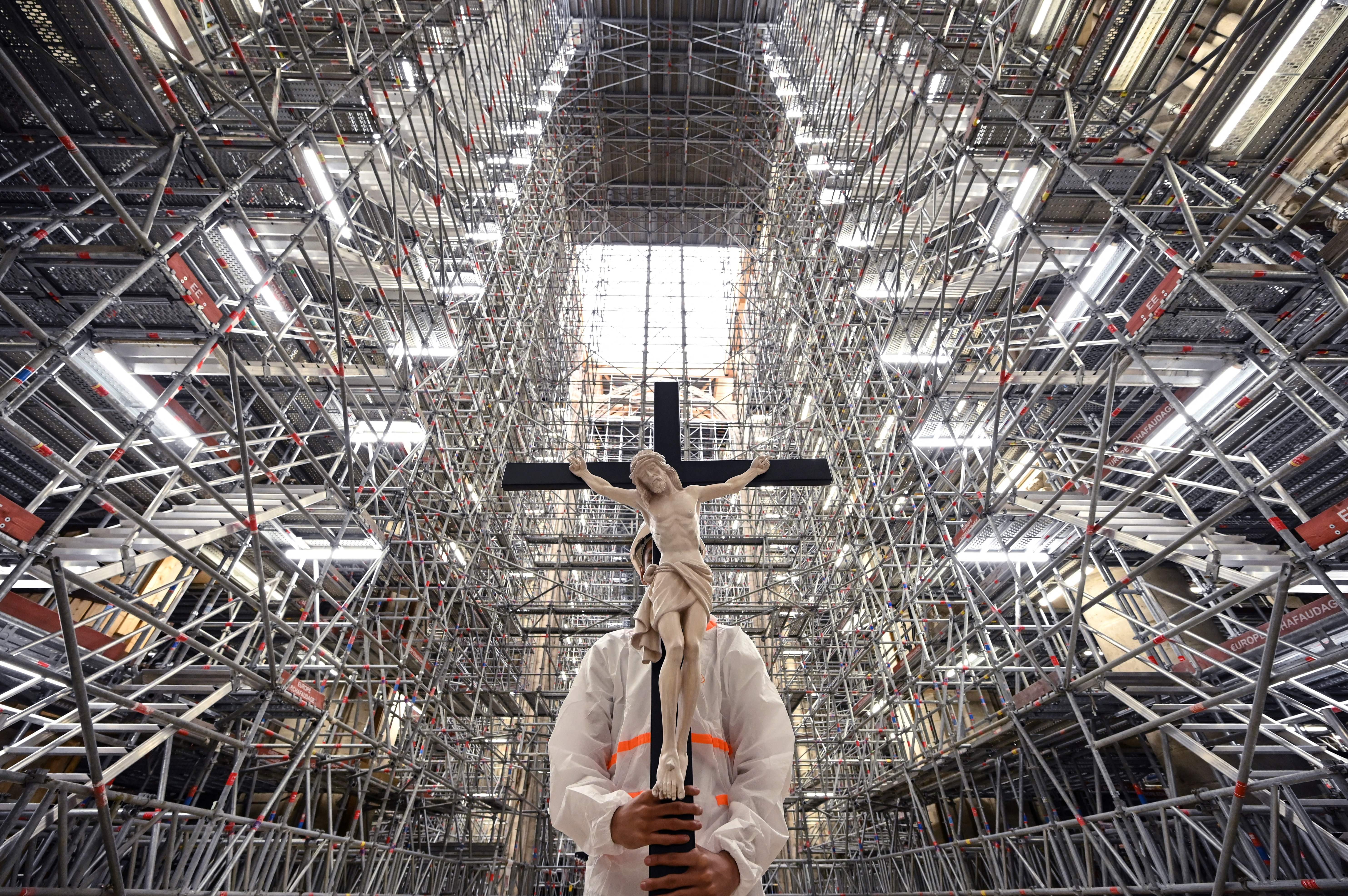 A catholic faithful holds a crucifix during a Good Friday Meditation prayer