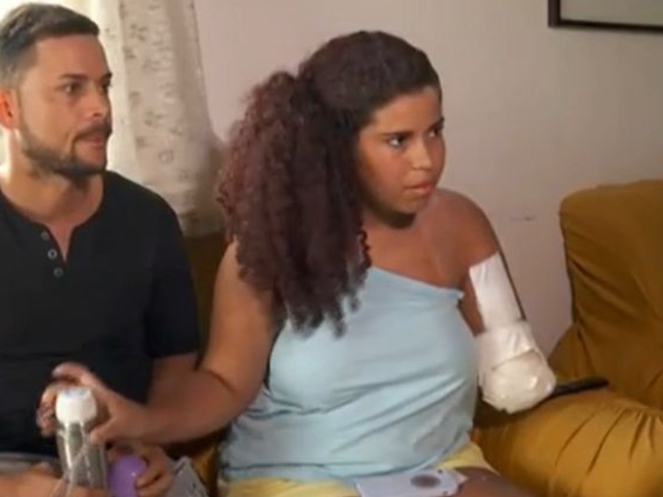 Kaylanne Timoteo Freitas, 15, with her father, Wilque Barros Freitas, discussing her injuries following a shark attack