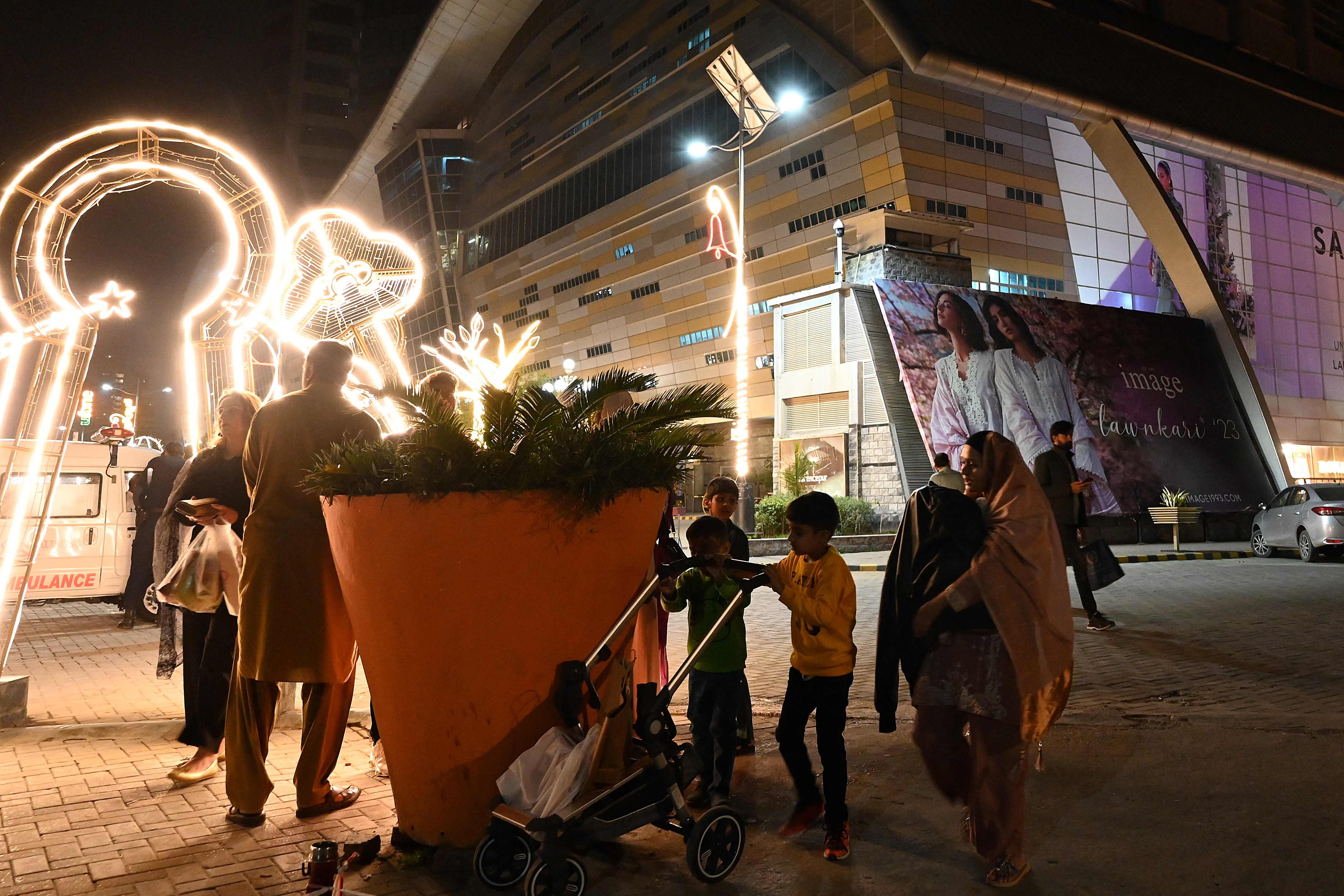 People gather outside a mall following an earthquake in Islamabad, Pakistan