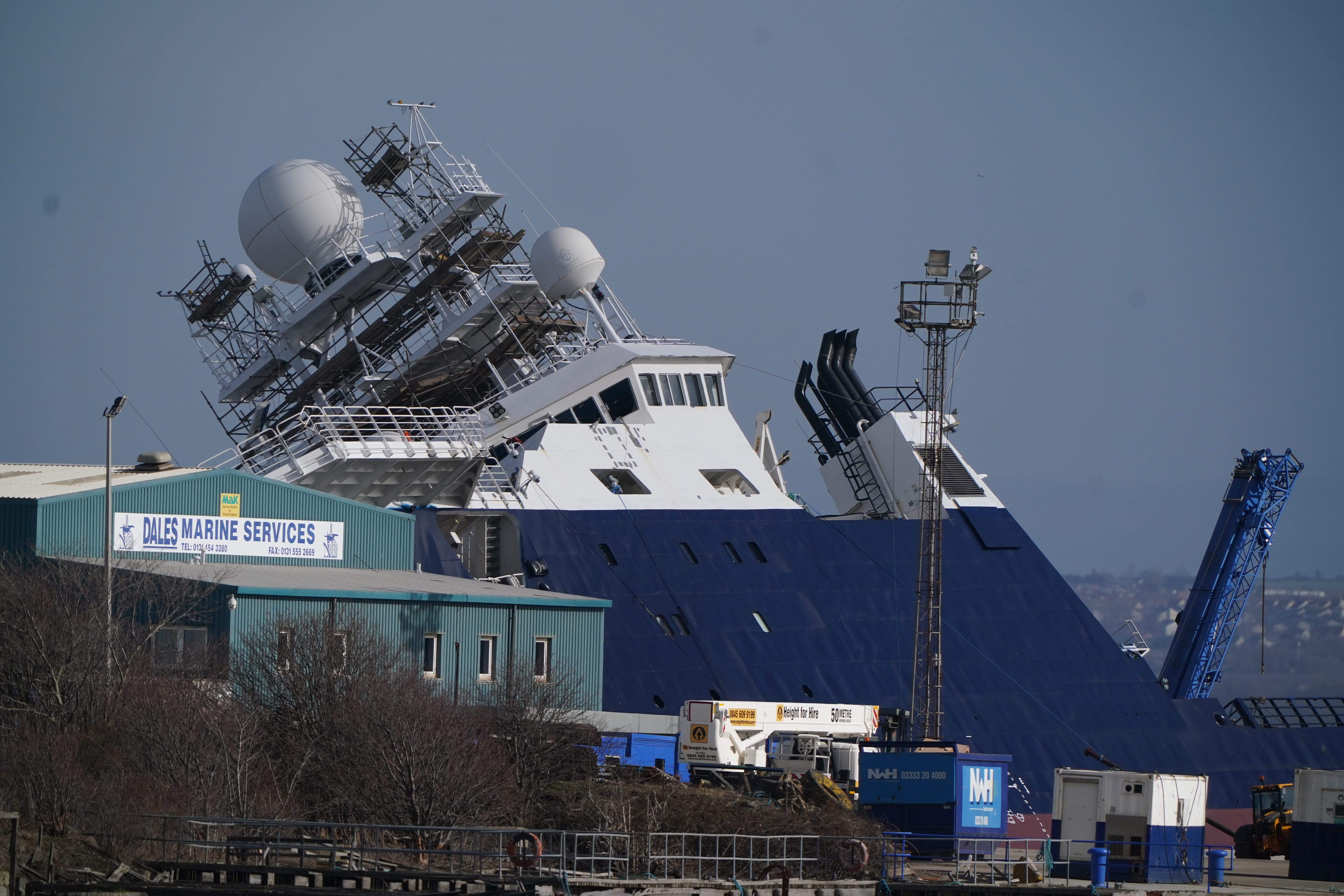 Emergency services at Imperial Dock in Leith, Edinburgh, where a ship has become dislodged from its holding and is partially toppled over (Andrew Milligan/PA)