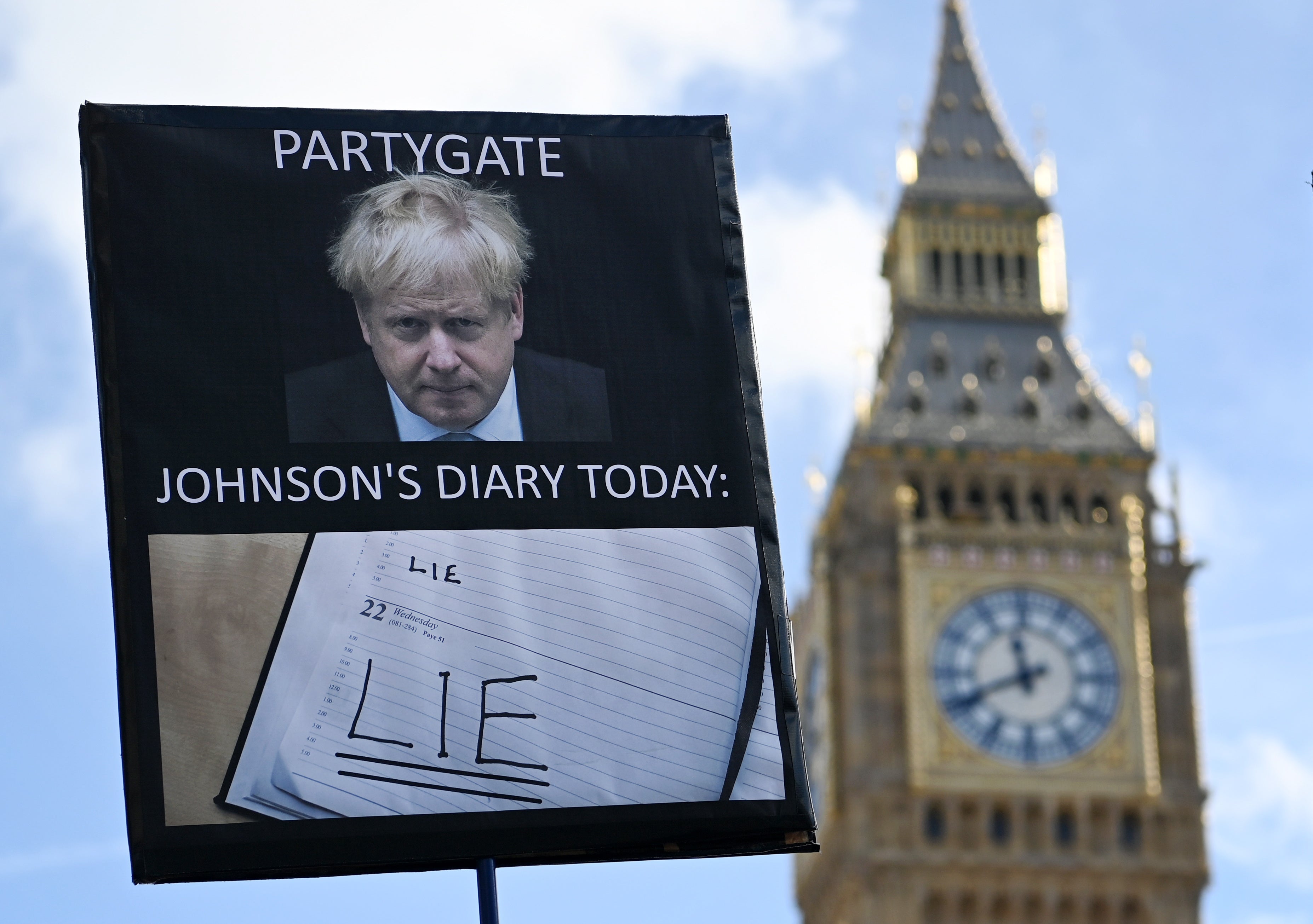 A protester demonstrates against former prime minister Boris Johnson outside parliament in London this week