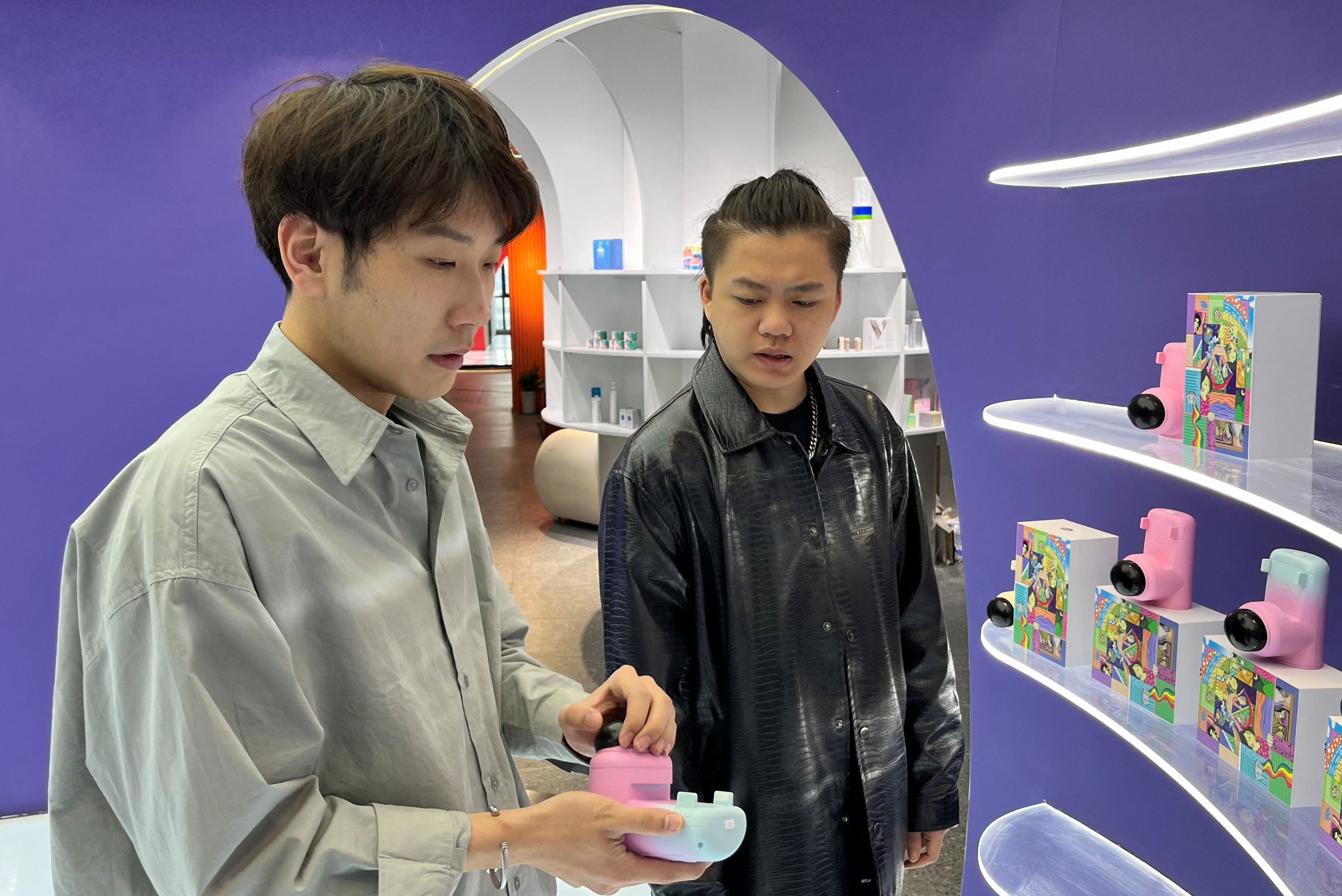 Zhao Jianbo, founder of the remote kissing device “Long Lost Touch” demonstrates products for the camera during an interview with Reuters, at an office in Hangzhou, Zhejiang