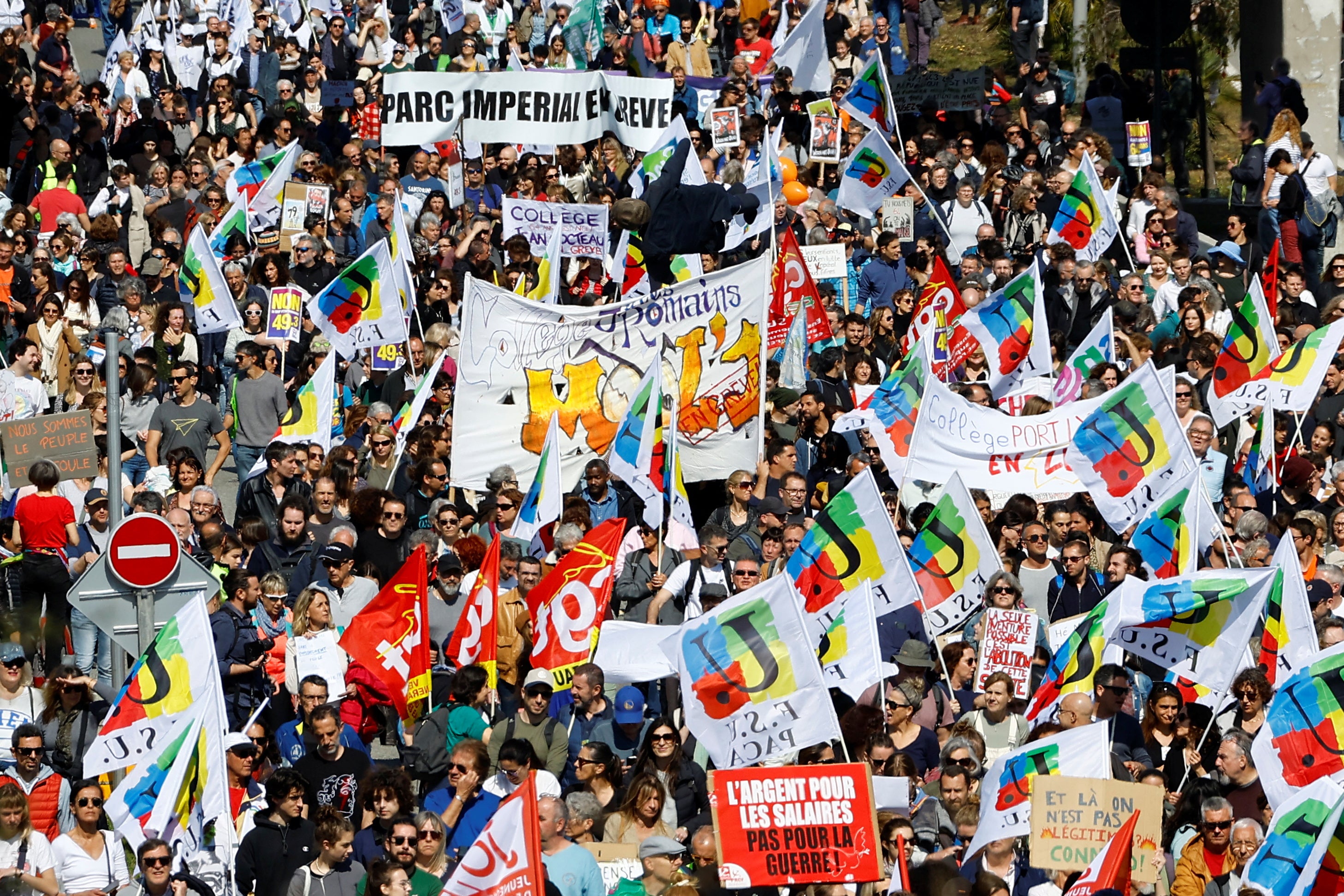 Protesters holds French labour union flags during a demonstration as part of the ninth day of nationwide strikes