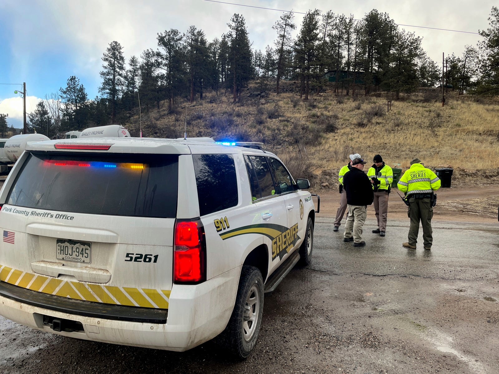 Law enforcement on the scene where Austin Lyle’s car was located, with his body found close by