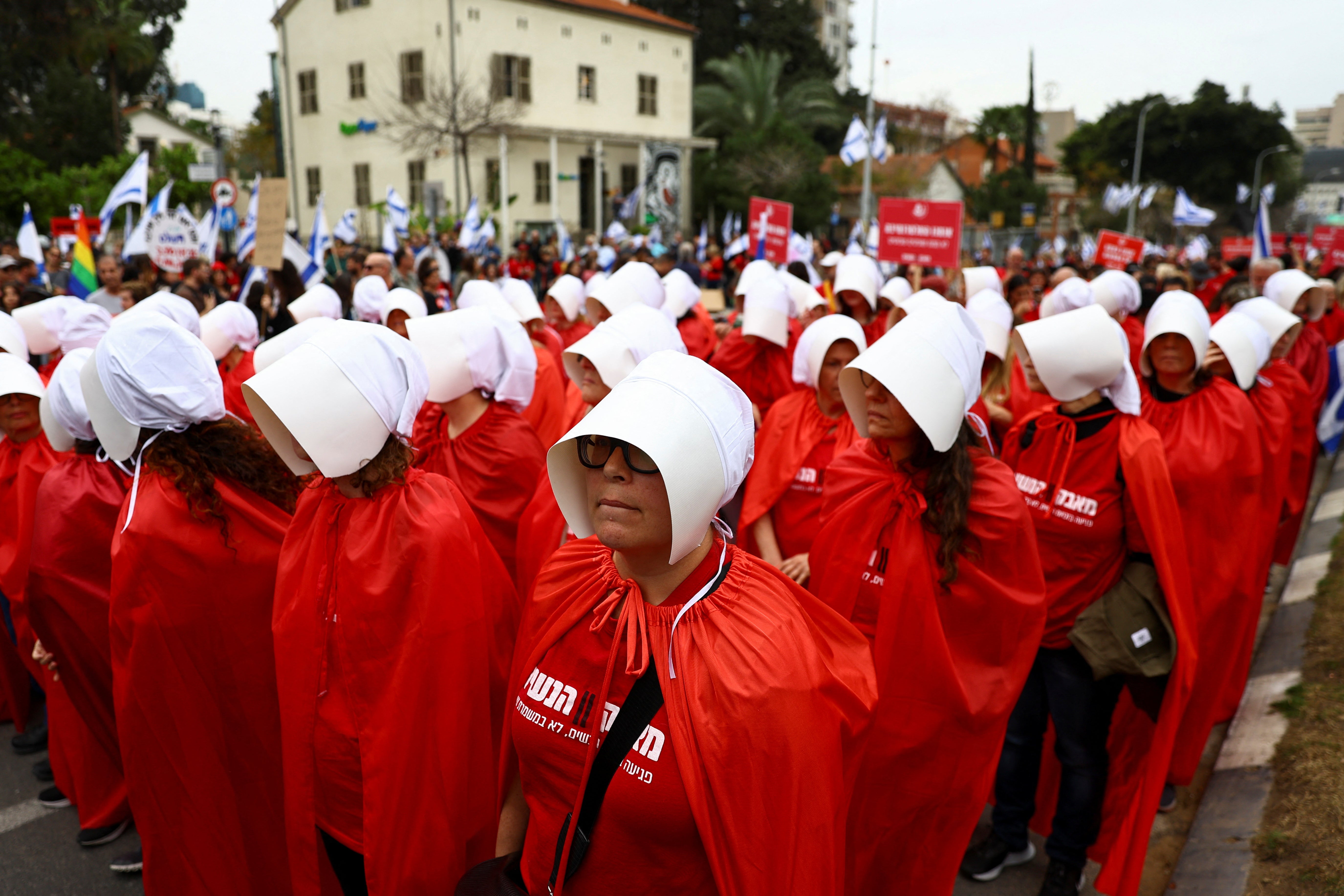 Demonstrators dressed as handmaidens from ‘The Handmaid’s Tale’ take part in protests in Israel on Thursday