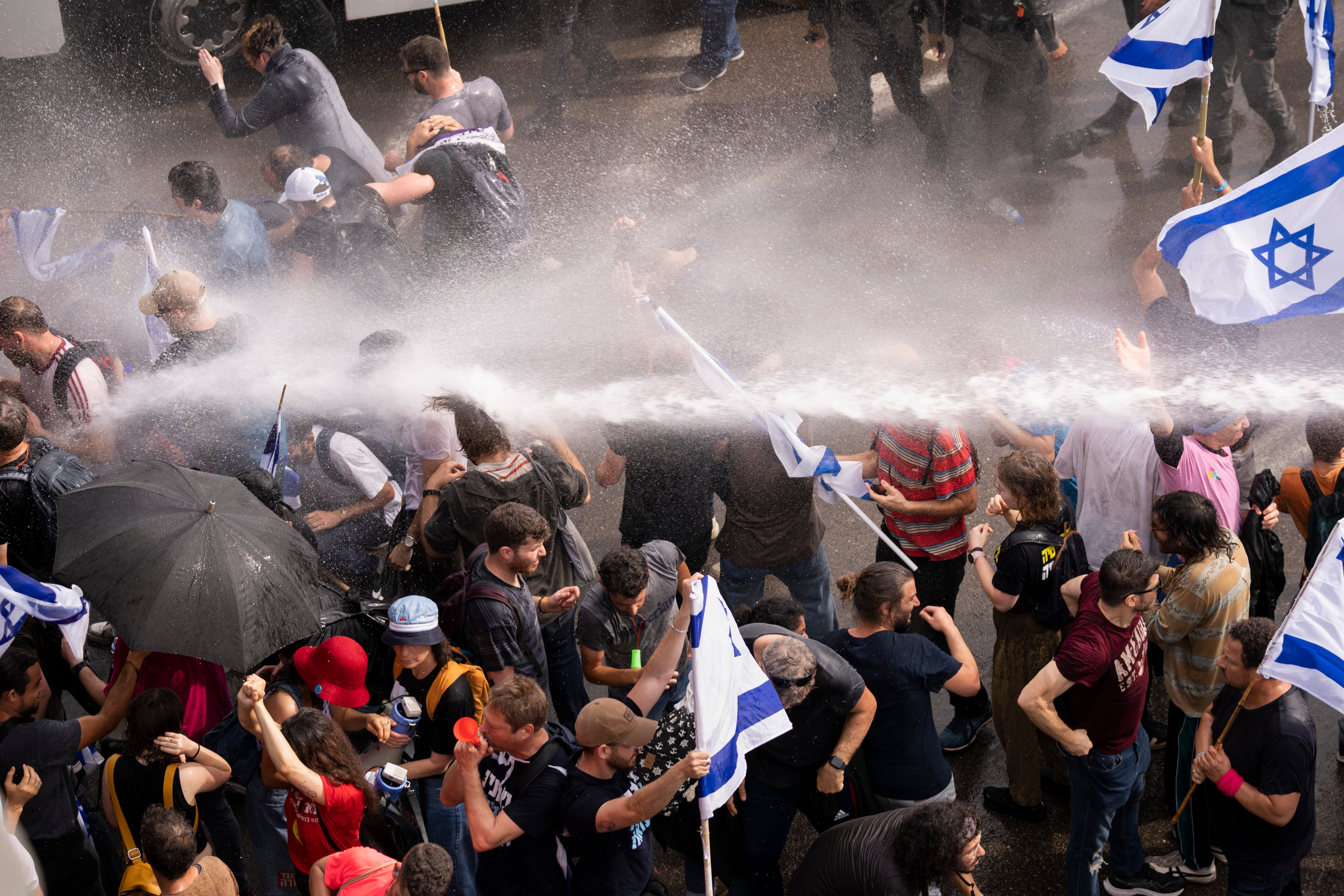 Israeli police use a water cannon to disperse protesters in Tel Aviv