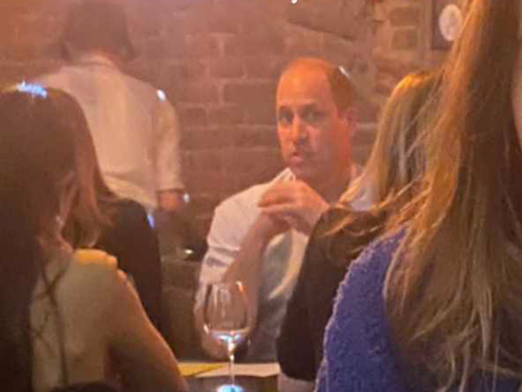 Prince William dines with patrons at the Butero Bistro in Warsaw, Poland