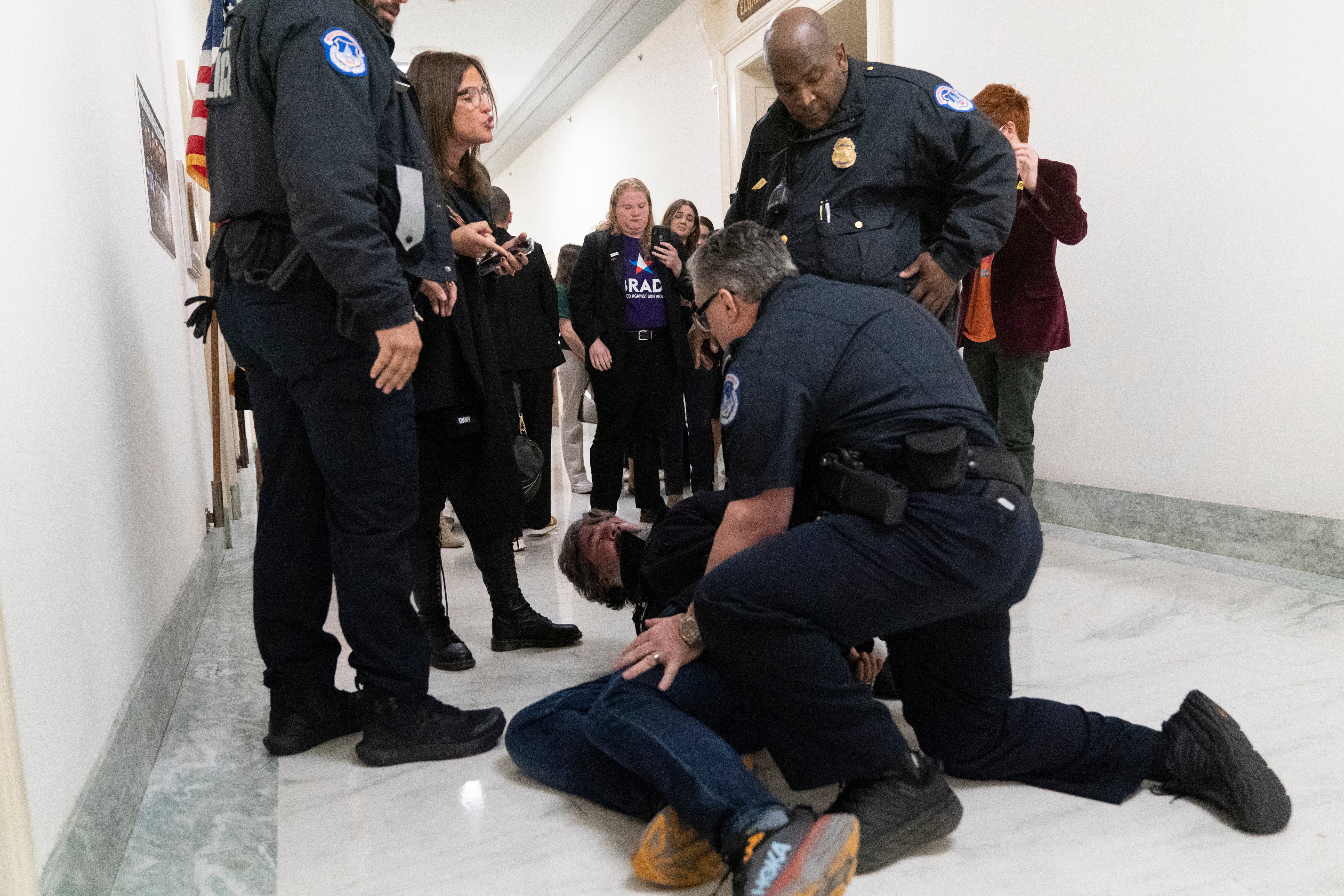 Capitol Police pin Manuel Oliver to the floor outside the committee room