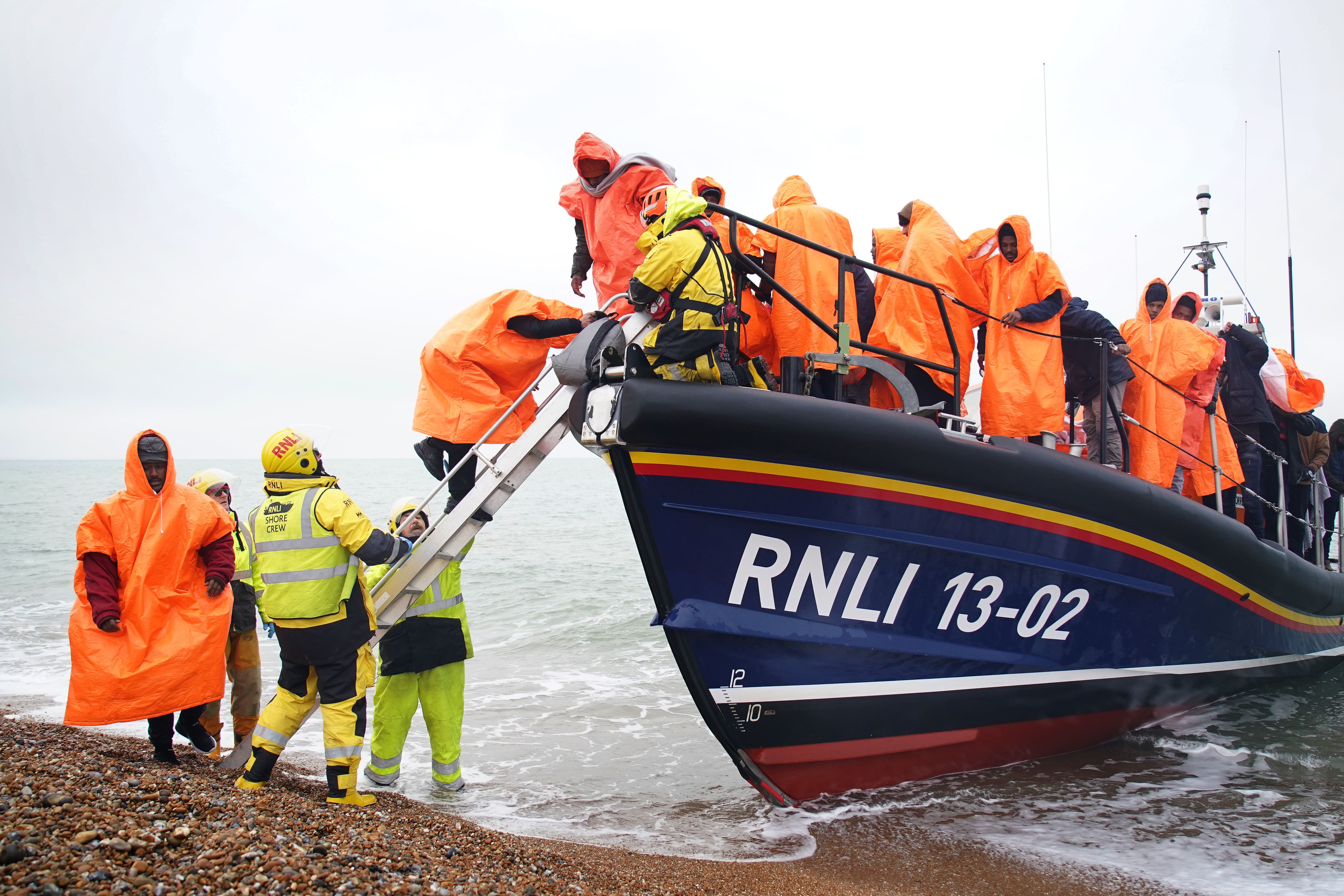 A group of people thought to be migrants are brought in to Dungeness, Kent. Climate change is expected to increase the number of people seeking refuge in other countries (Gareth Fuller/PA)