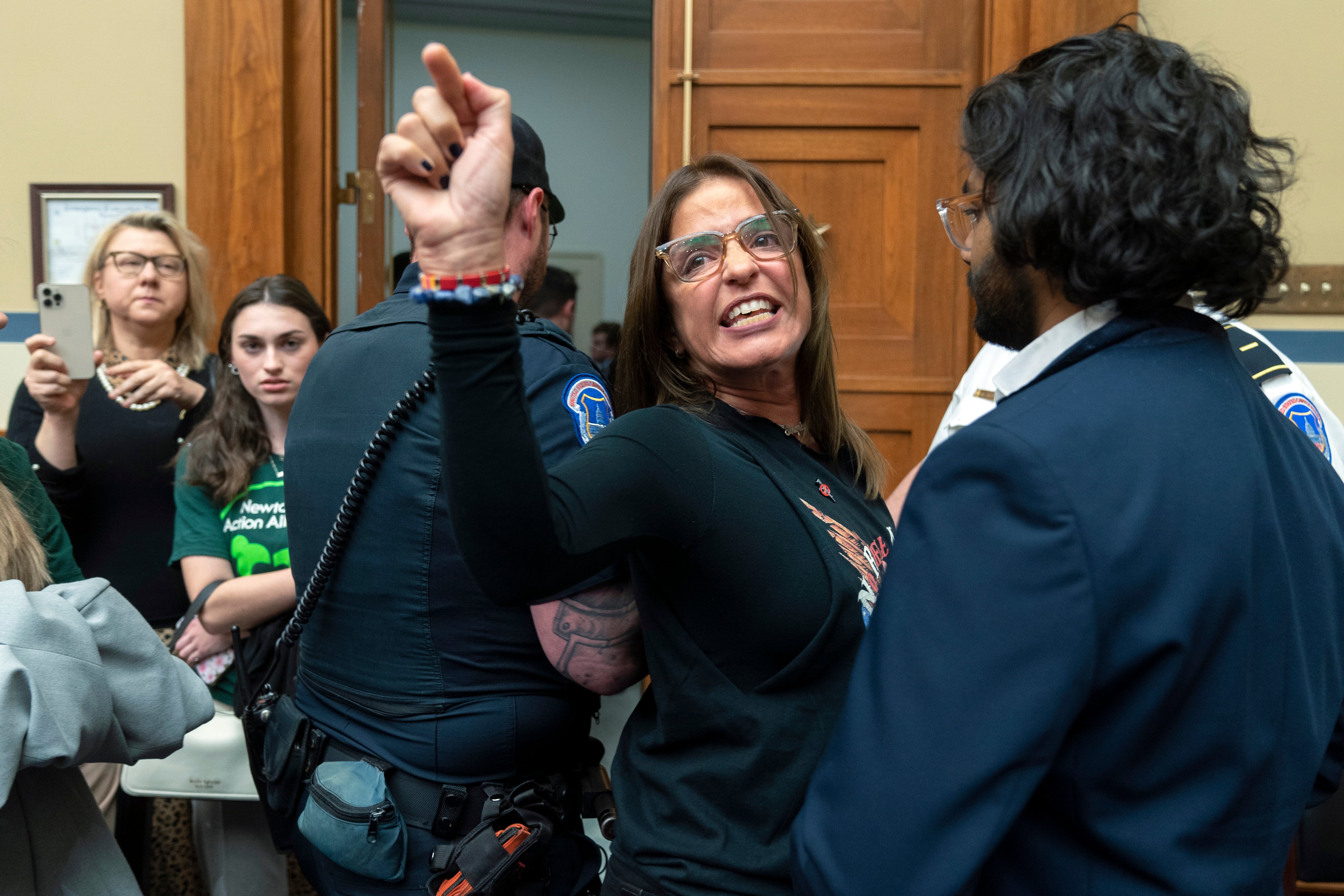 Patricia Oliver is removed from the hearing on gun violence. She and her husband Manuel lost their son Joaquin in the 2018 Parkland school shooting