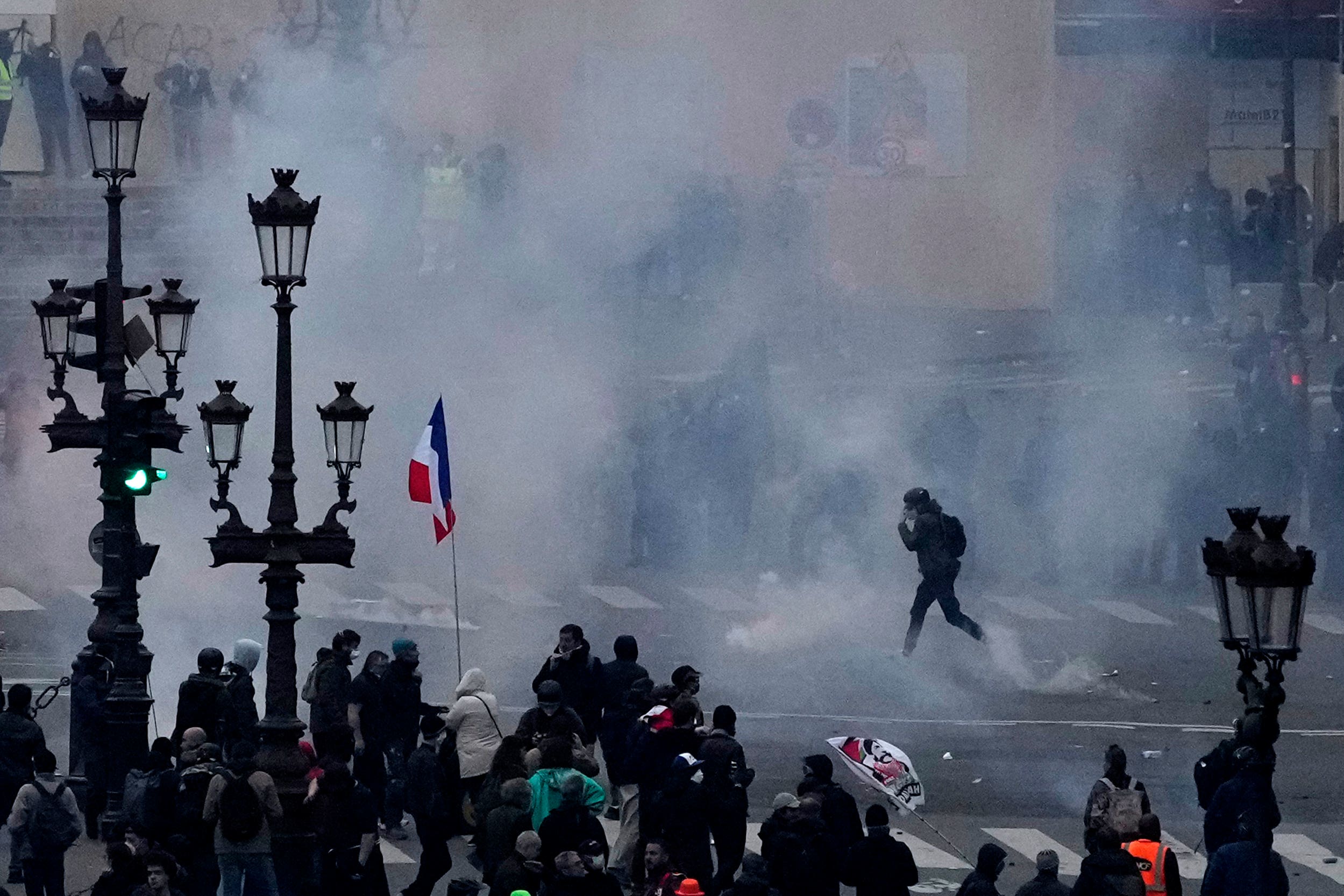 Protesters scuffle at the end of a rally in Paris on Thursday (AP Photo/Christophe Ena)