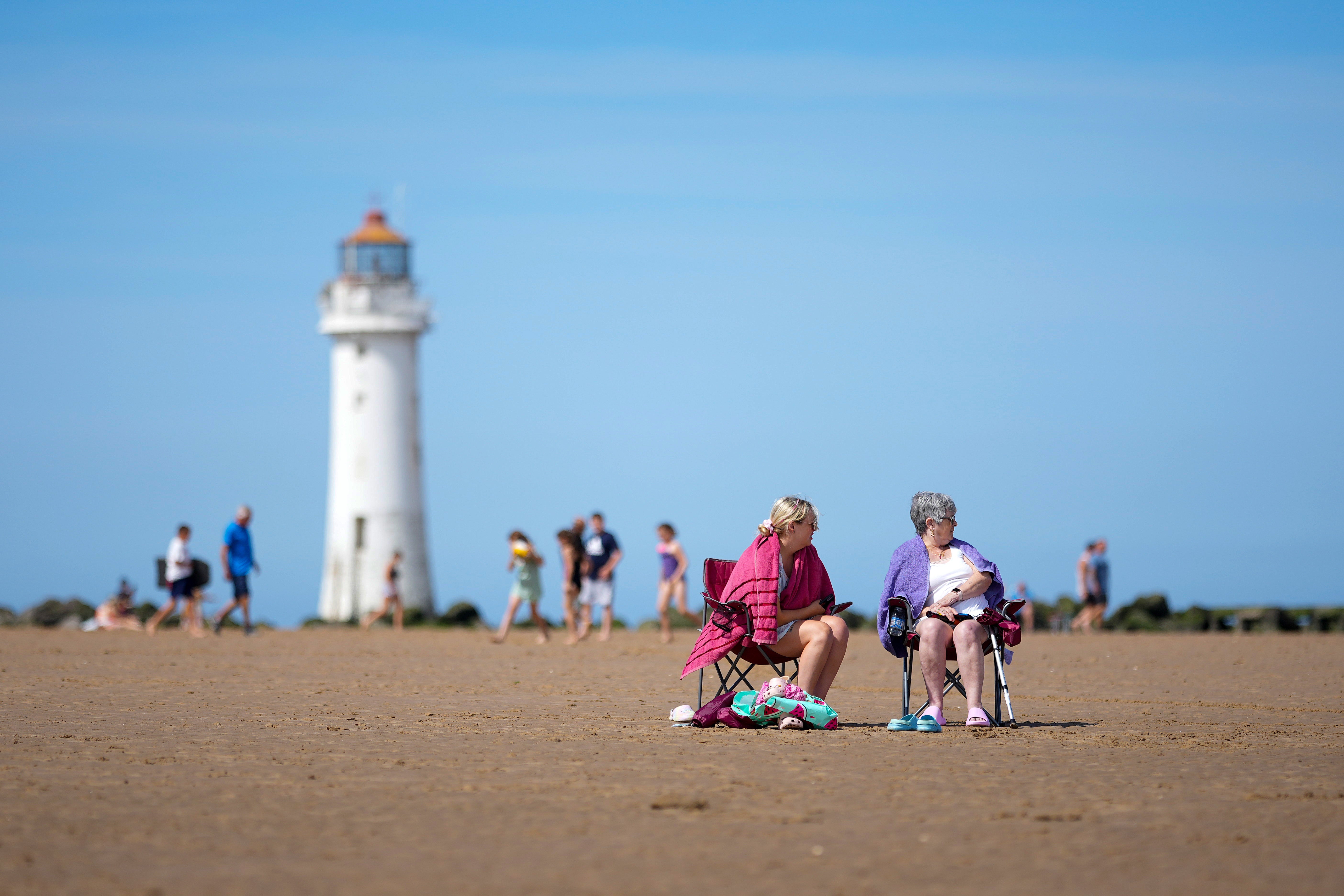 People enjoy the warm weather and sunshine on New Brighton beach