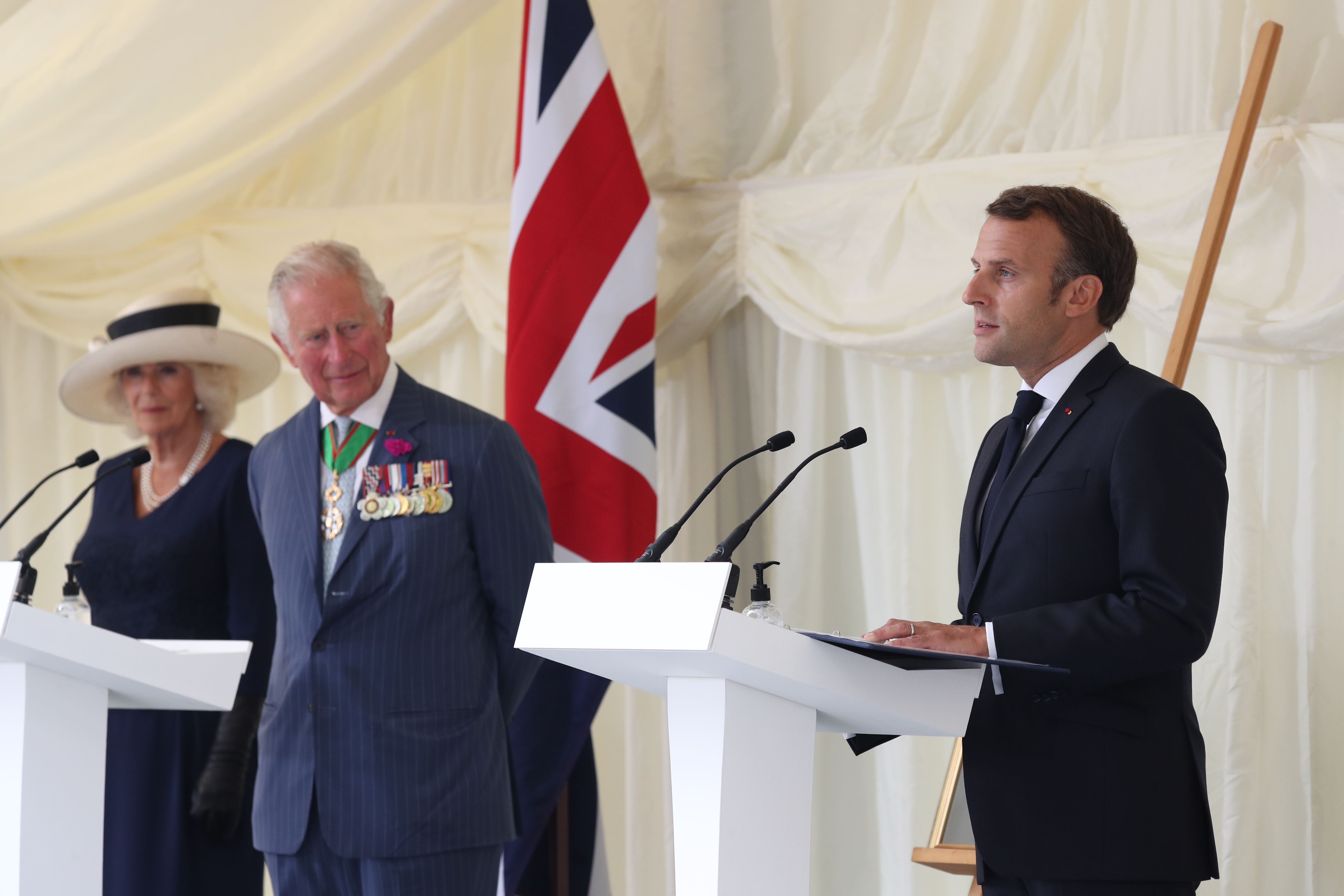 French President Emmanuel Macron, watched by the then-Prince of Wales and Duchess of Cornwall during a ceremony at Carlton Gardens in London during his visit to the UK in 2020 (Jonathan Brady/PA)