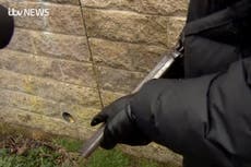 Masked man pulls out loaded gun during interview with ITV News